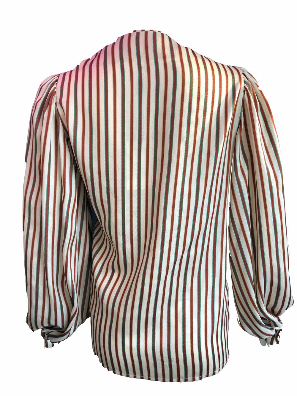 Striped boxy blouse by Hermes in cream with maroon, yellow and green stripes. Features puffy sleeves and v neck. Excellent condition.

100% silk

Size 38