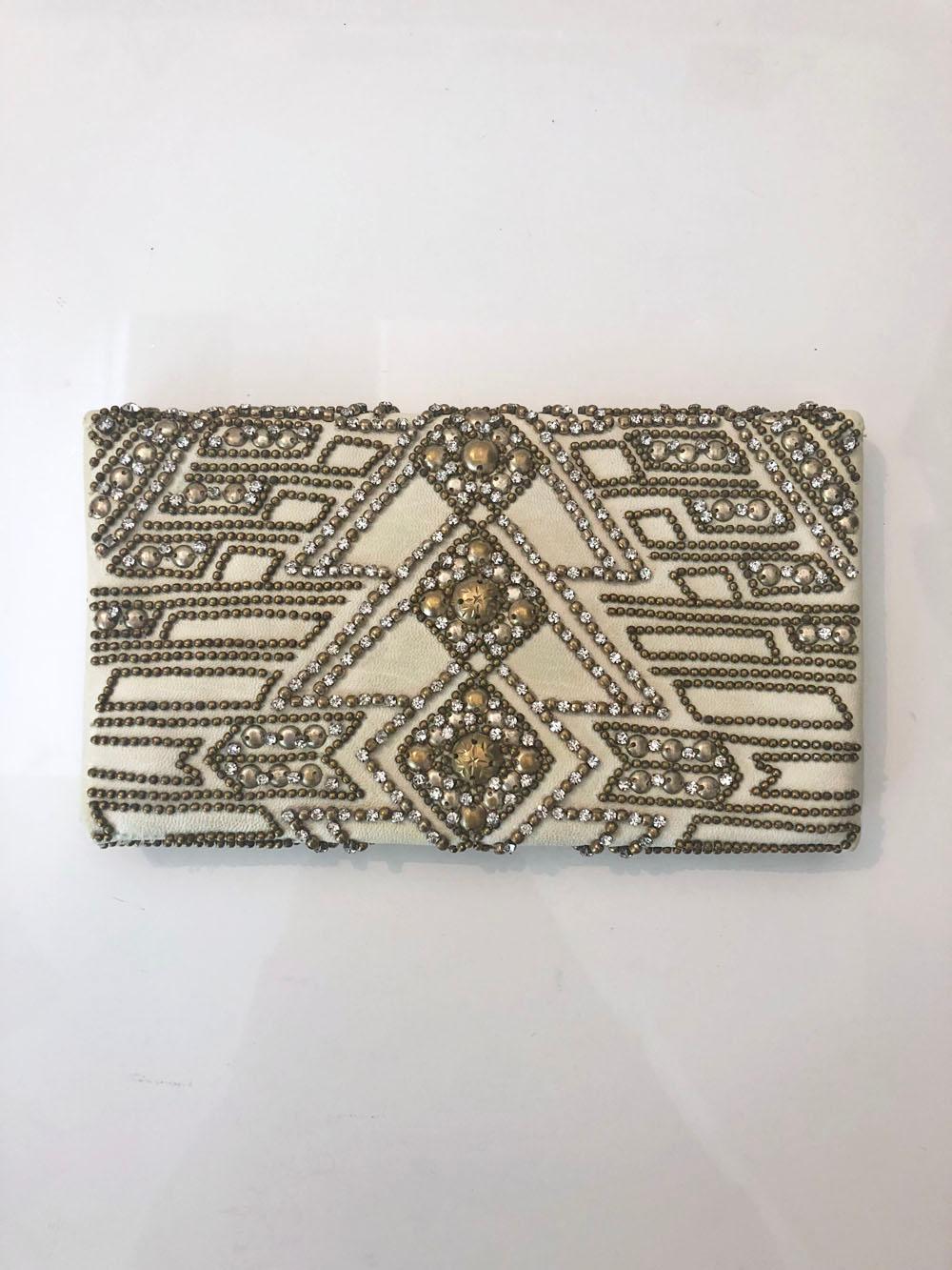 Cream buttery leather envelope clutch by Balmain embellished with studs, beads, and rhinestones. This item has been cleaned and is in excellent condition! 

