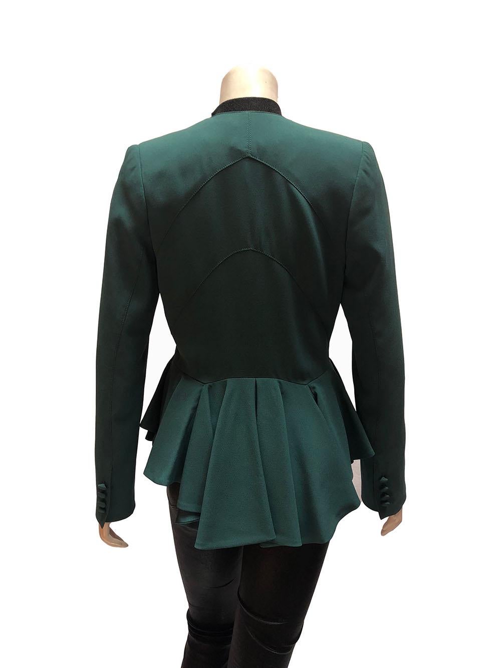 Zac Posen teal blazer with cinched waist and narrow lapels. Structured ruffle construction along the bottom below the waist, three button closure, and shoulder pads. New with tags attached. Size 40. 