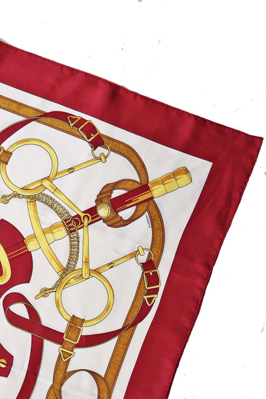 This vintage Hemes  scarf in the Eperon D’or pattern was design by  Henri D’Origny. 
-White, golds tones and wine red. 
-Features an equestrian print. 
-Marked 