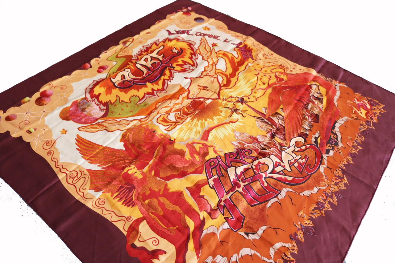 Hermes Aube Libre Comme L' Ange rust, red, orange and yellow scarf
Hermes silk scarf in rust, red, orange and yellow tones. Graffiti, fire, and cherub design print.

-Square Scarf 
-Great condition 
-Retail prince: $415+



