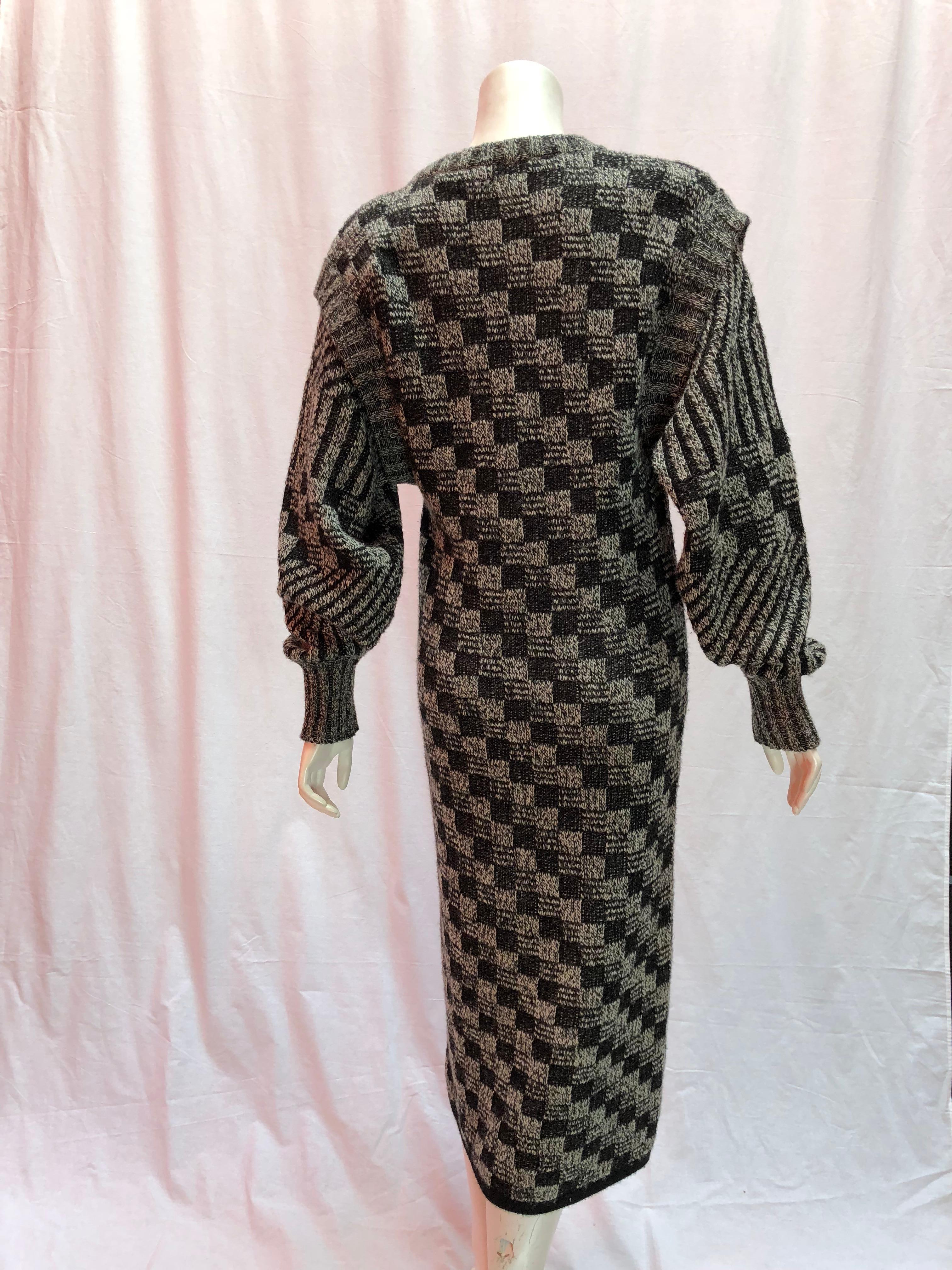 Yves Saint Laurent Vintage Maxi Sweater Dress. 
Black and White knit. This cozy sweater dress and a great edition to your winter wardrobe. The garment is made out of wool and is vintage. 
Size 40, but fits small. Arms are slight ballon style and