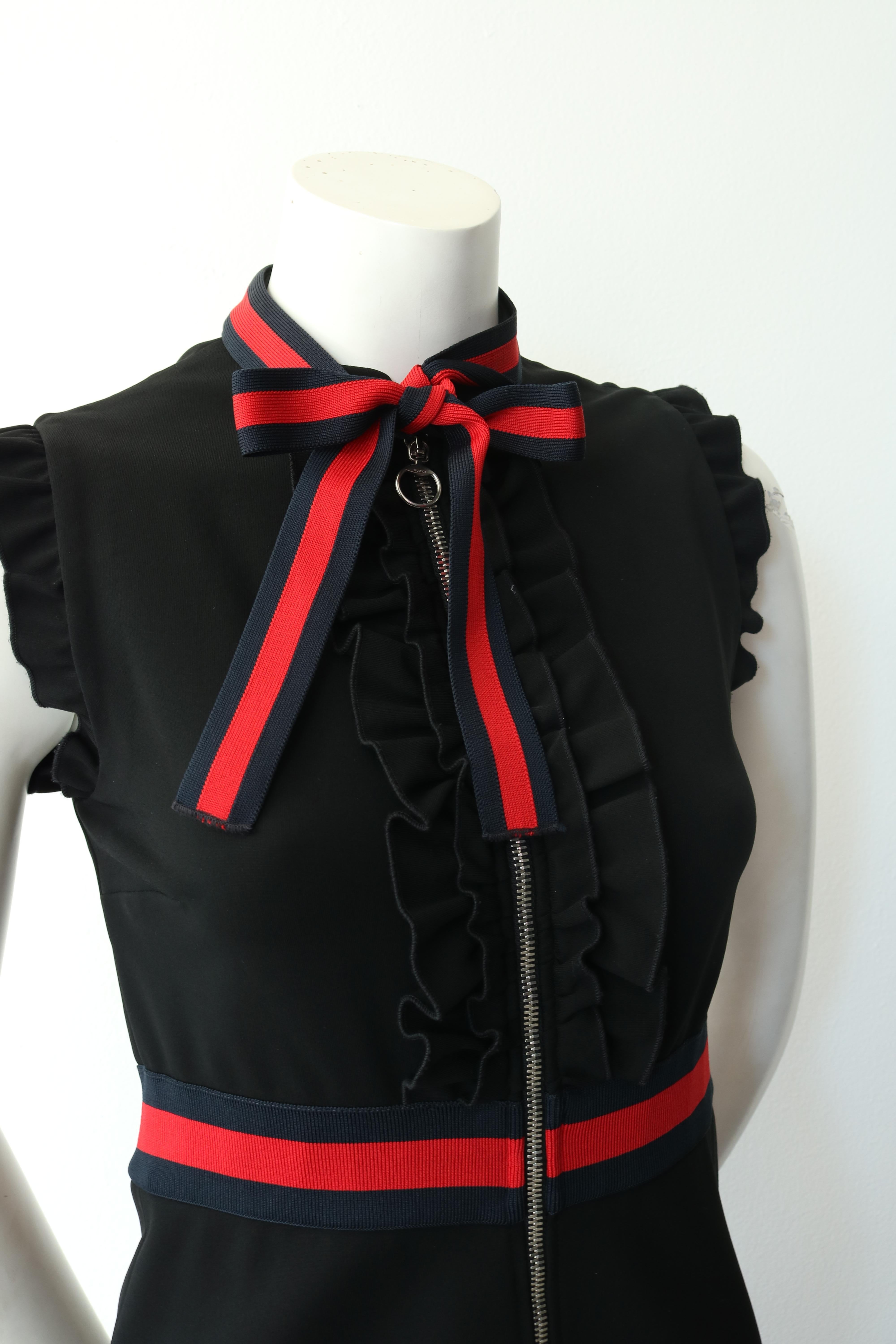 -The dress is further enhanced by knitted Web trim on the waistband and on the neckline knotted into a decorative bow. 
-Black compact viscose jersey with blue and red knitted Web detail. 
-Ruffle detail on front placket and sleeves. 
-Front zip.