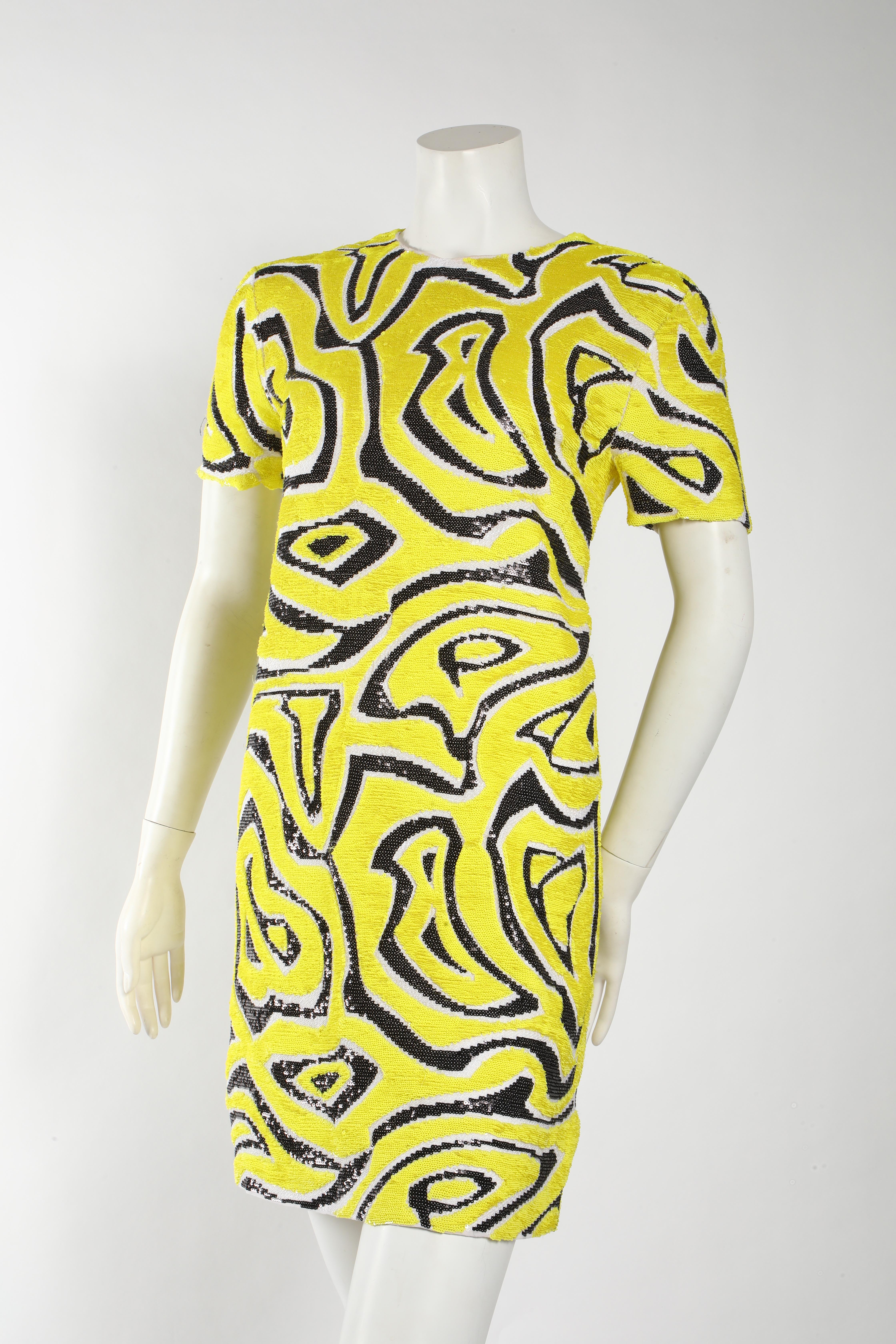 This eye catching Emilio Pucci sequin cocktail dress is the perfect statement piece! The yellow and black design is made out of sequins for a little sparkle. 

Retailing for $4170 it is in mint condition and has no signs of wear. 
The silhouette is