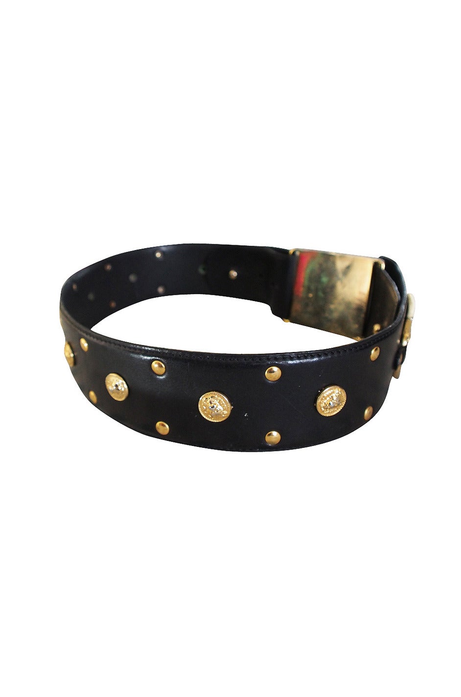 The signature Versace gold lion's head adorn the heavy gold tone metal detailing on the belt at the front and around the belt on the large studs. A classic and I love the width that really allows a cinched in, wasp waist silhouette.

Stamped a