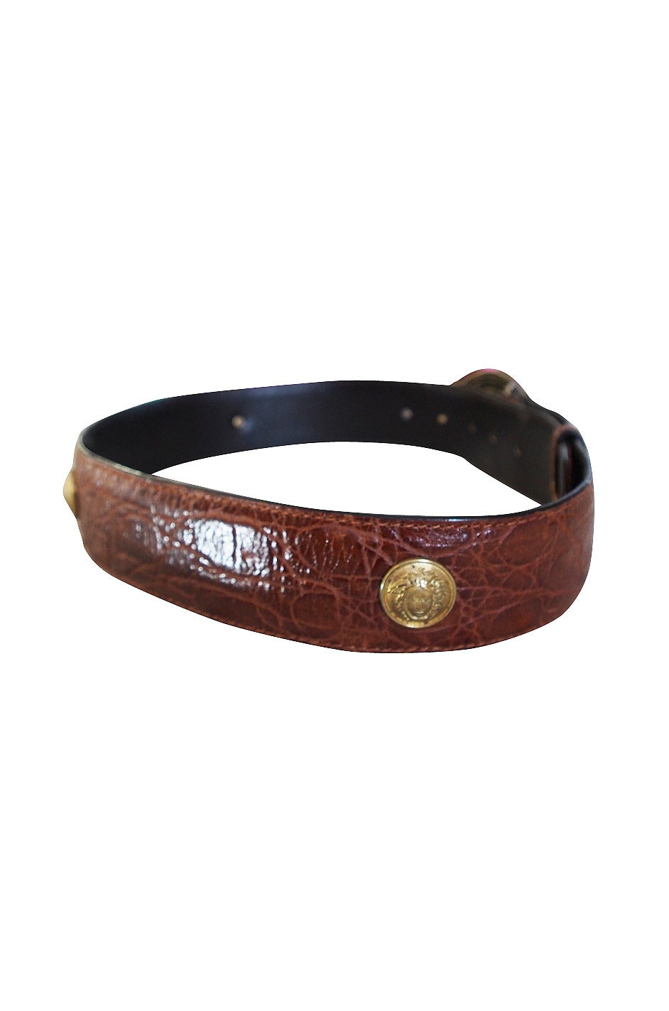 The signature Versace Medusa head adorn the heavy brass buckle and detailing on the belt at the front and also appear around the belt on the large studs. A stunning exotic skin that shows no soigns of wear or dryness. A classic and I love the width
