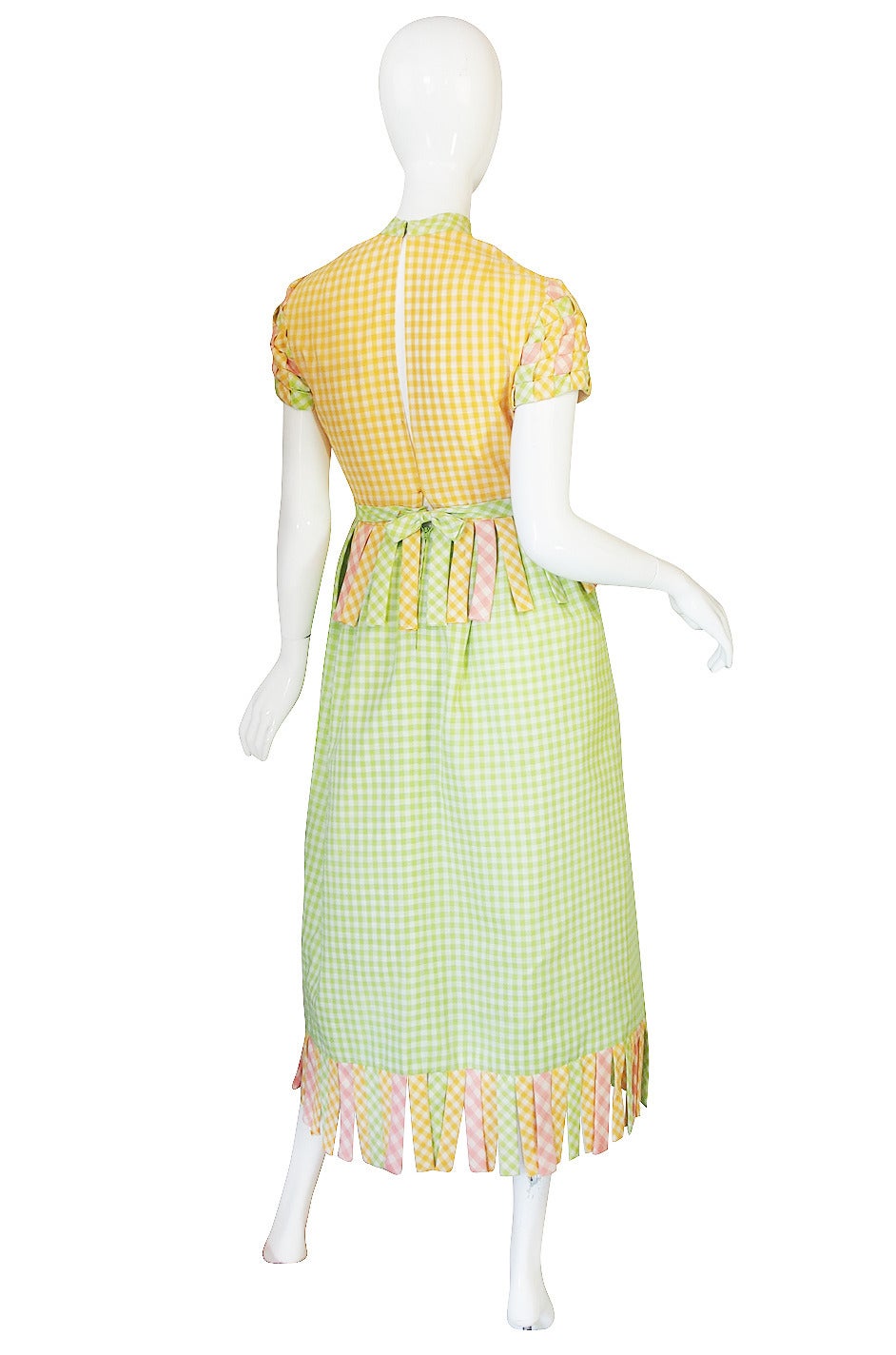 The work on this dress is amazing. Made of a cotton printed in three colors of gingham - yellow, green and pink - it feels shockingly modern and works in perfectly with a modern wardrobe as it has a very cutting edge feel despite its use of such a