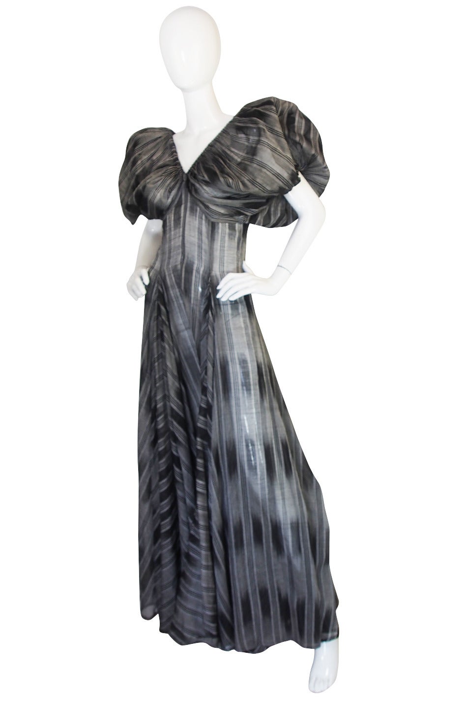 This dress is constructed from a semi-sheer silk voile that is bias cut ad done in shades of grey. The gown has an exceptional sleeve and bodice treatment that gives it a fantastic haute couture feel. Yves based many of the gowns for the Rive Gauche