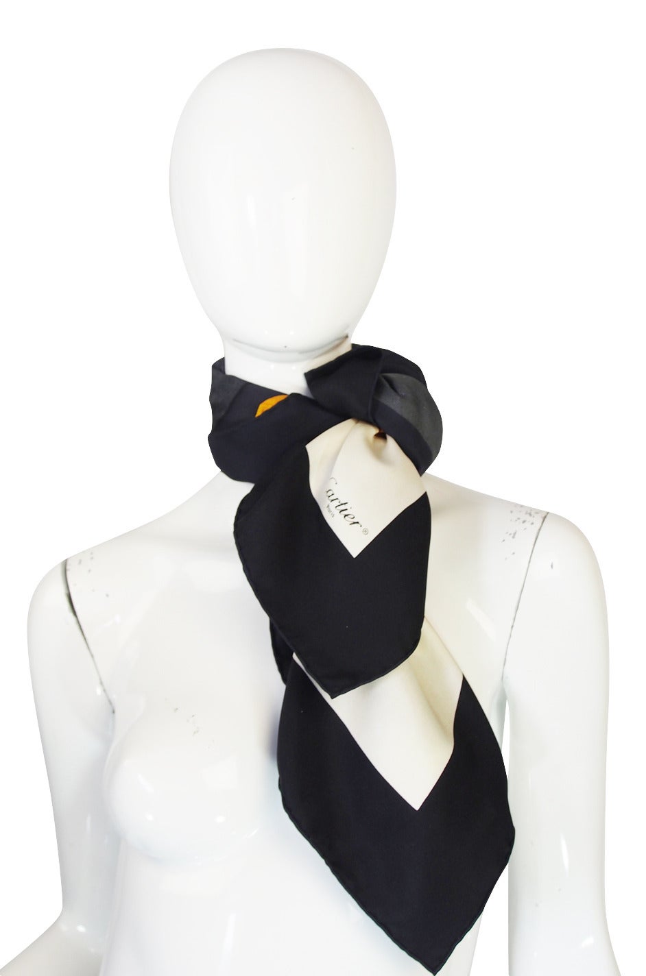 Beautiful silk twill Cartier scarf done with a classic print of the iconic Panthere cuff in alternating squares of black and white. The colors are bright and vibrant and it is quintessentially Cartier.

Appears to have been never been used or used