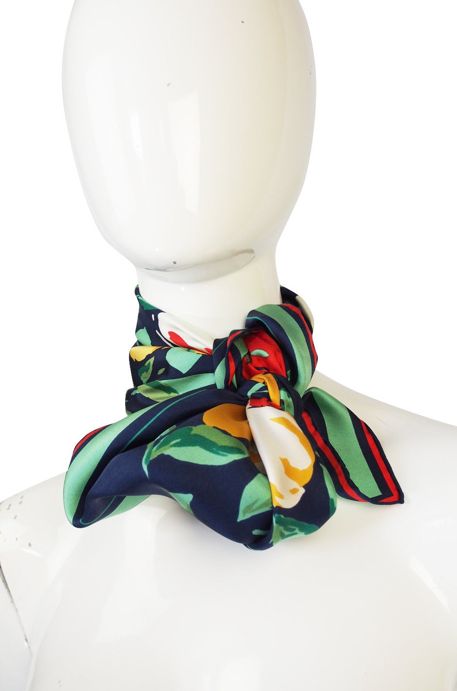 Beautiful silk Christian Dior scarf in a fabulous combination of a deep blue base with a brilliant floral print and red edges with a large signature of the Christian Dior name on one corner. The colors are bright and vibrant and because of the