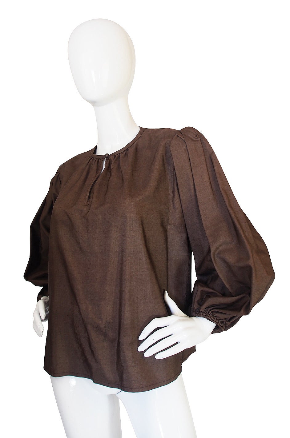 This stunning, loose fitting pheasant style top is fabricated from a fabulous polished raw silk in a milk chocolate that is very flattering on almost any skin tone. The loose and easy cut are a signature Yves nod to sexiness and this particular