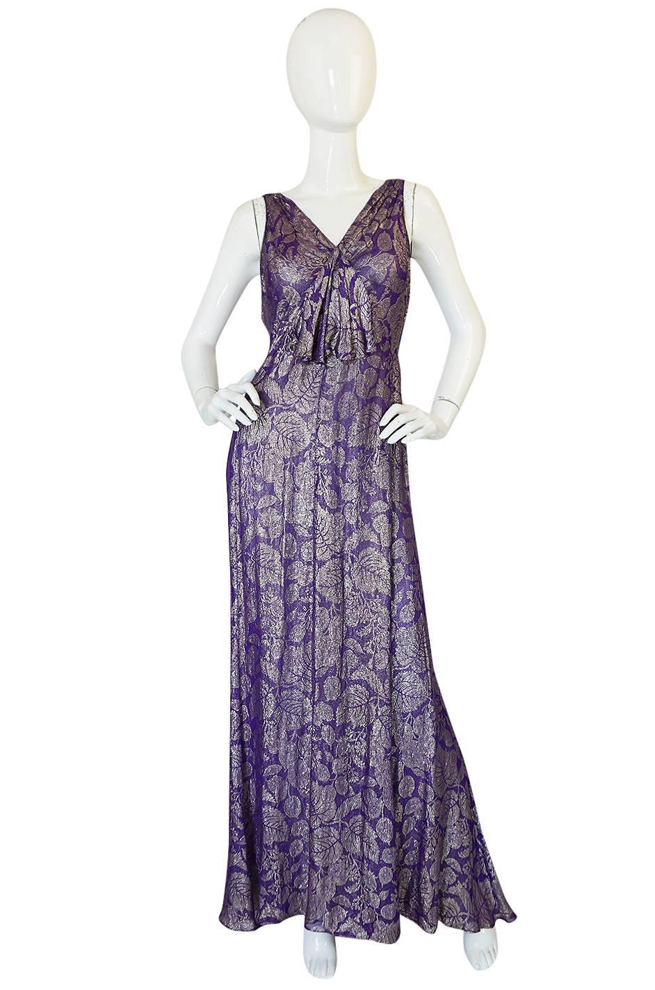 

This extraordinary and exquisite, late 1920s, early 30s bias cut gown is made from a spectacular mix of real metallic gold and purple thread. It is truly a masterpiece and really a work of art. It is one of the most spectacular gowns from this