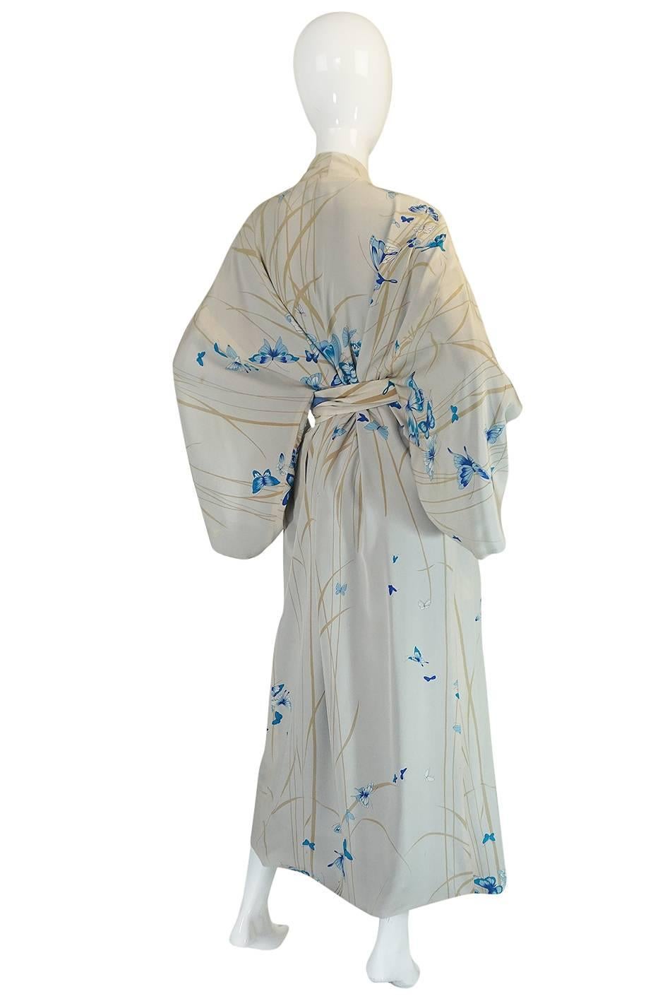

This stunning silk kimono from Hanae Mori has a dreamy and romantic print in shades of blues that range from the palest of colors to a deeply saturated pastel. It looks to have never been worn or used and would be perfect to use as wedding kimono
