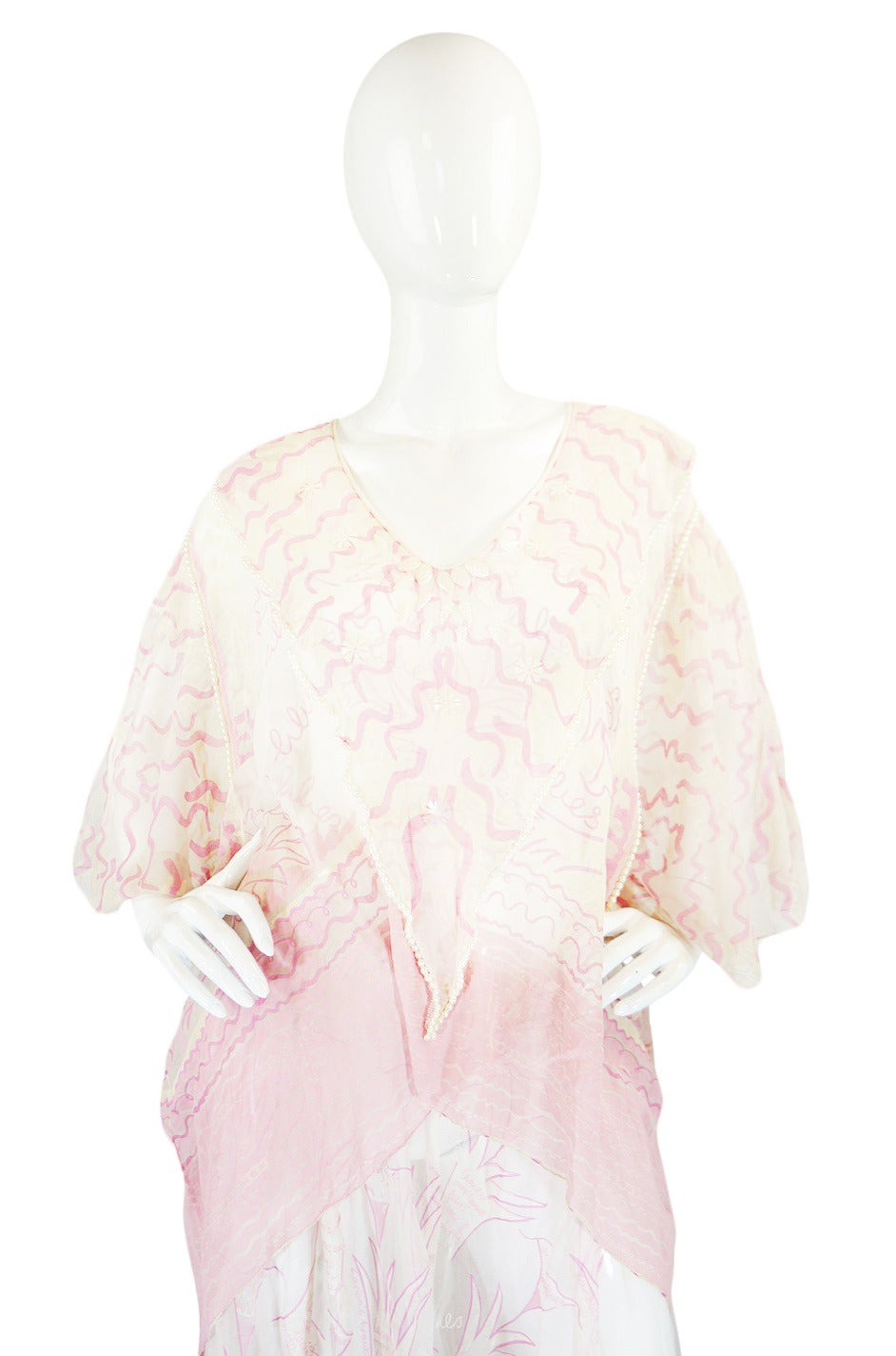 This two piece ensemble by Zandra Rhodes in not only rare, but is also quite beautiful. It is constructed from a fine white silk chiffon that is entirely hand painted with Zandra's famous 