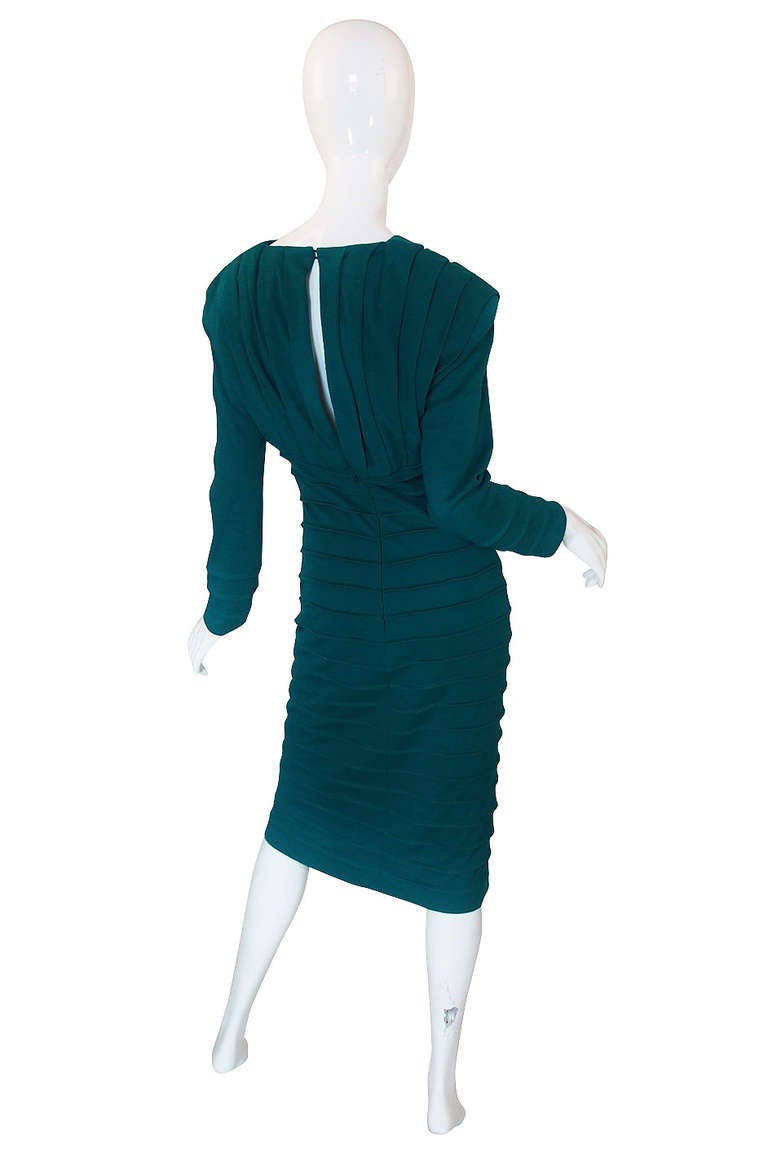 Body conscious dressing was all the rage in the 80s and though this may not be a piece you typically think of when you think Zandra it is a definite representation of its time. Made of a teal stretch, fine, wool, it is cut to fit an accentuate your