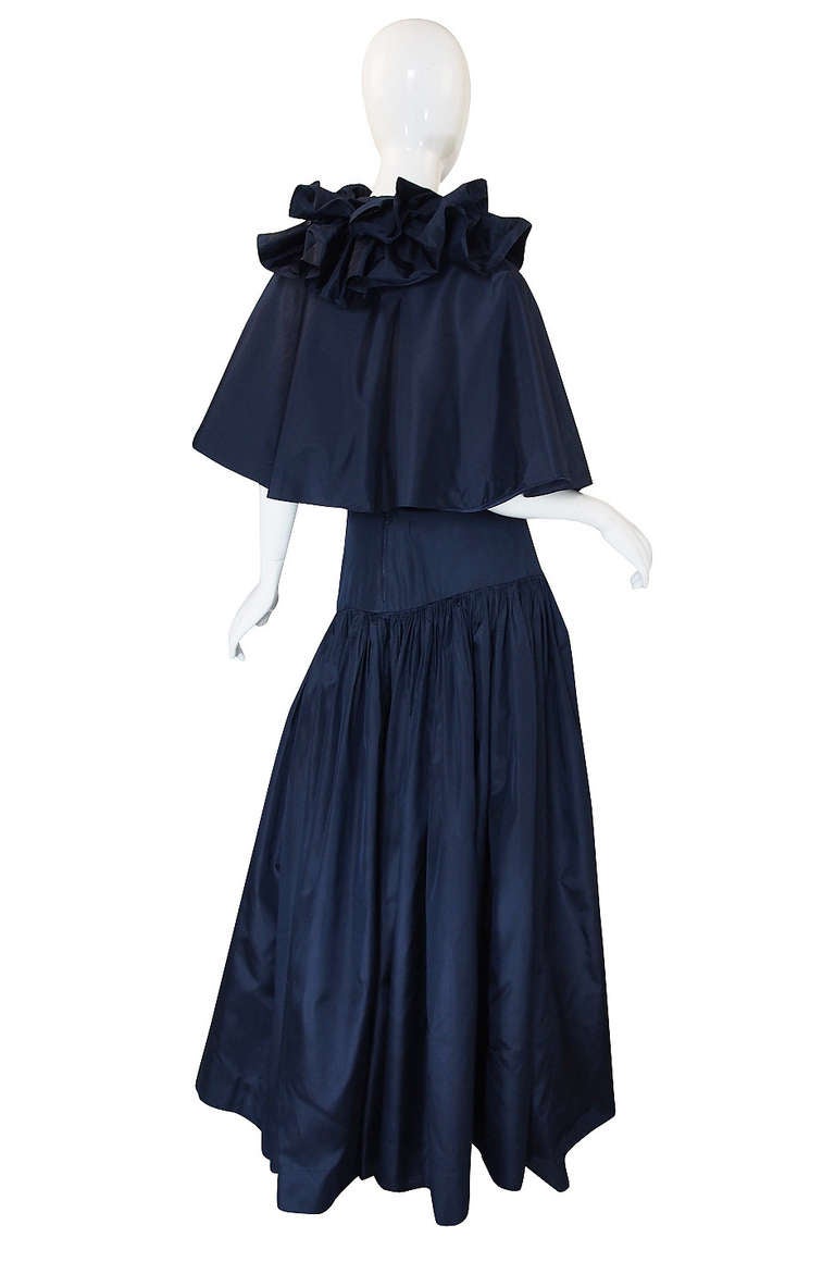 This set is unbelievably beautiful. Made form a deep blue silk taffeta that is just the epitome of what silk taffeta should be, it is cut masterfully and beautifully as one would expect form Chanel. The skirt flows to the floor in yards and yards of