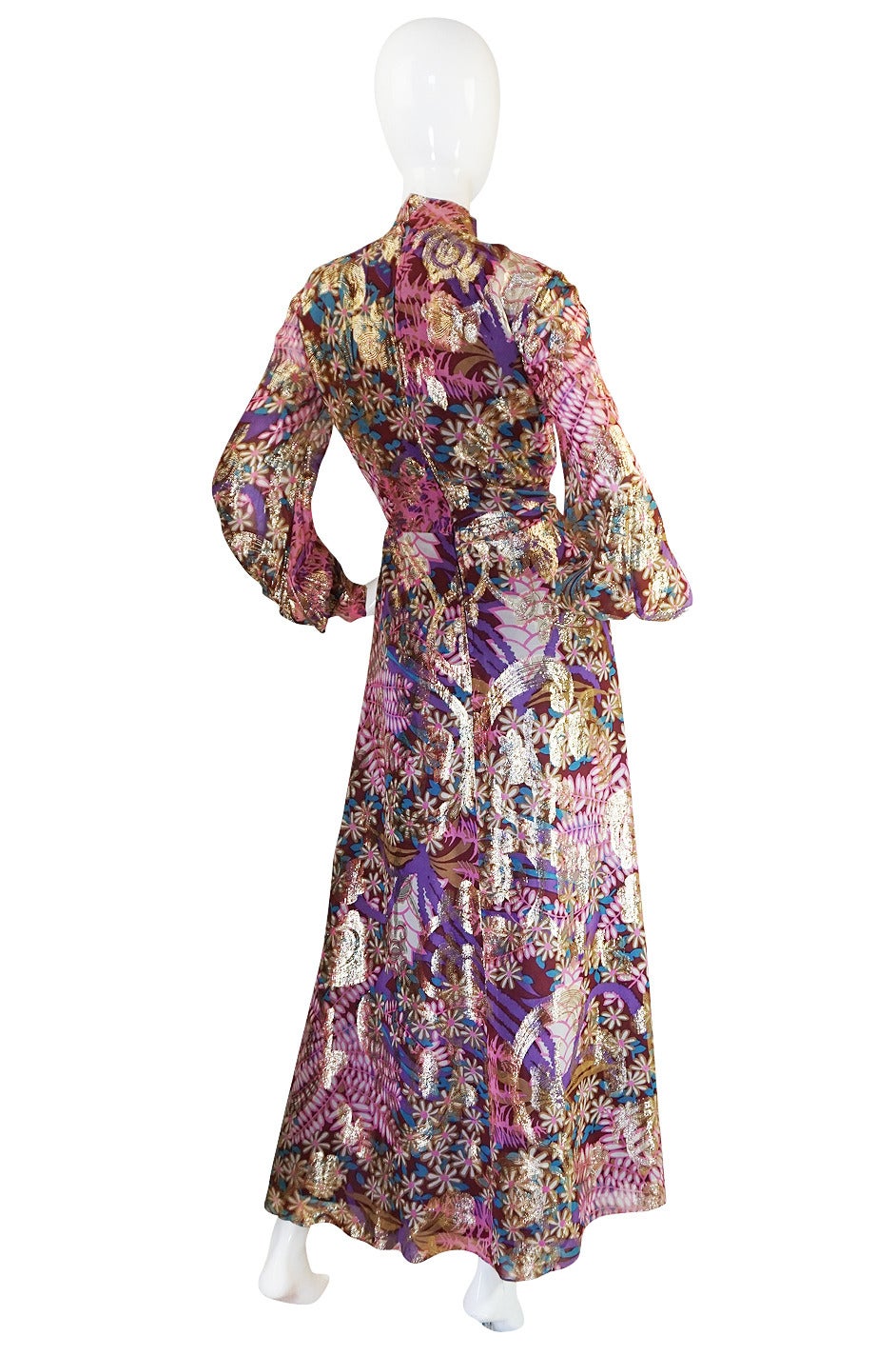 This is such an amazing dress. It is made by Malcolm Starr and it is a stunning example of why we love this label. The silk chiffon base is a pretty combination of pinks and shades of purple mixed together masterfully in a leaf and floral print.