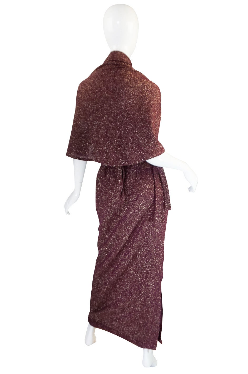 This is a unique and fabulous set comprised of a long and lean skirt and a swath of matching fabric that you can wrap and tie in endless ways to create a multitude of looks. Both pieces are made of a metallic lurex knit and the color is a deep wine