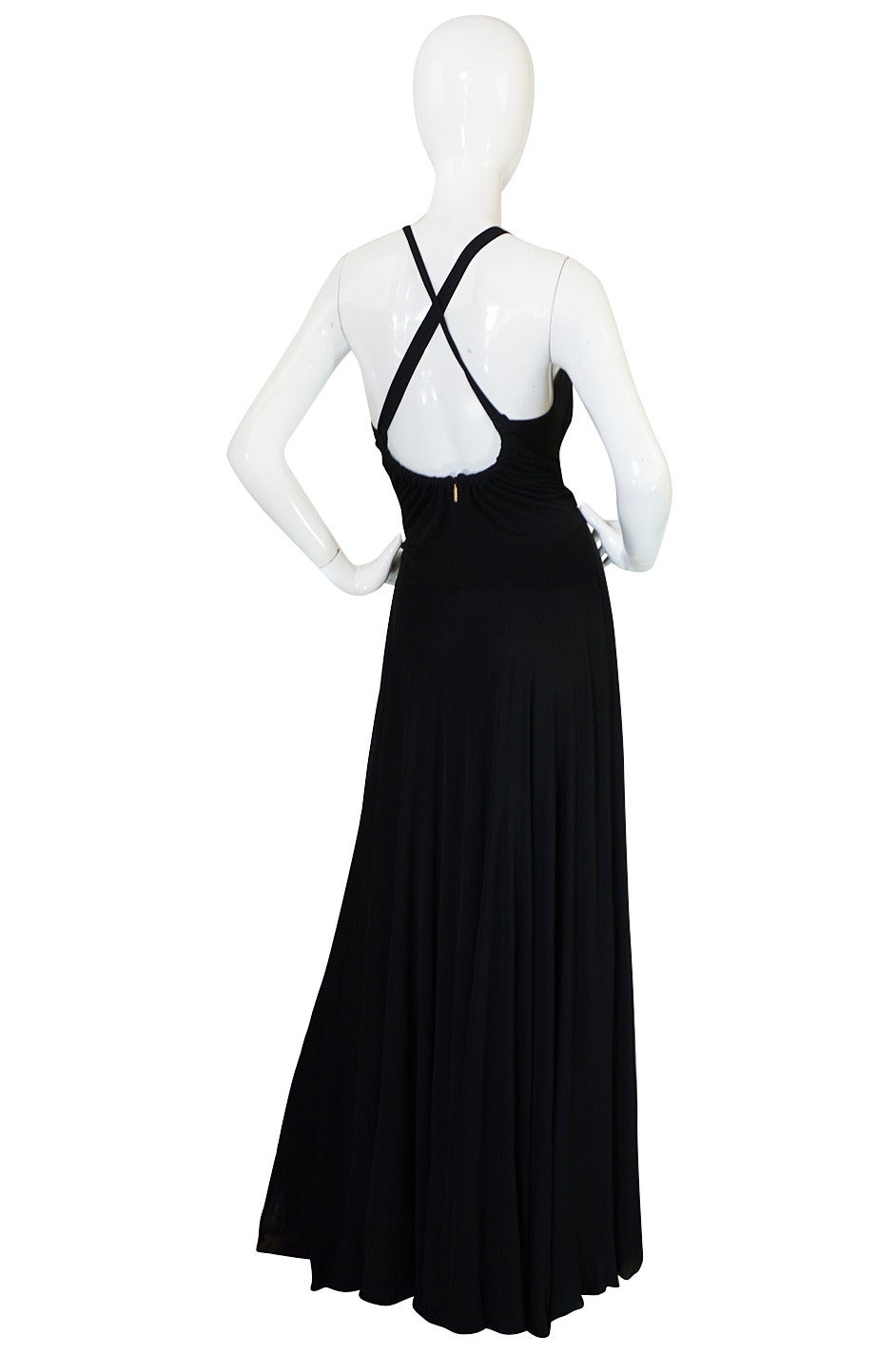 This gorgeous black silk jersey gown is pure Cavalli - it is both sexy and jet set chic. The gown is constructed of yards and yards of luxurious silk jersey that moves and drapes perfectly into place and is insanely comfortable to wear. The bodice
