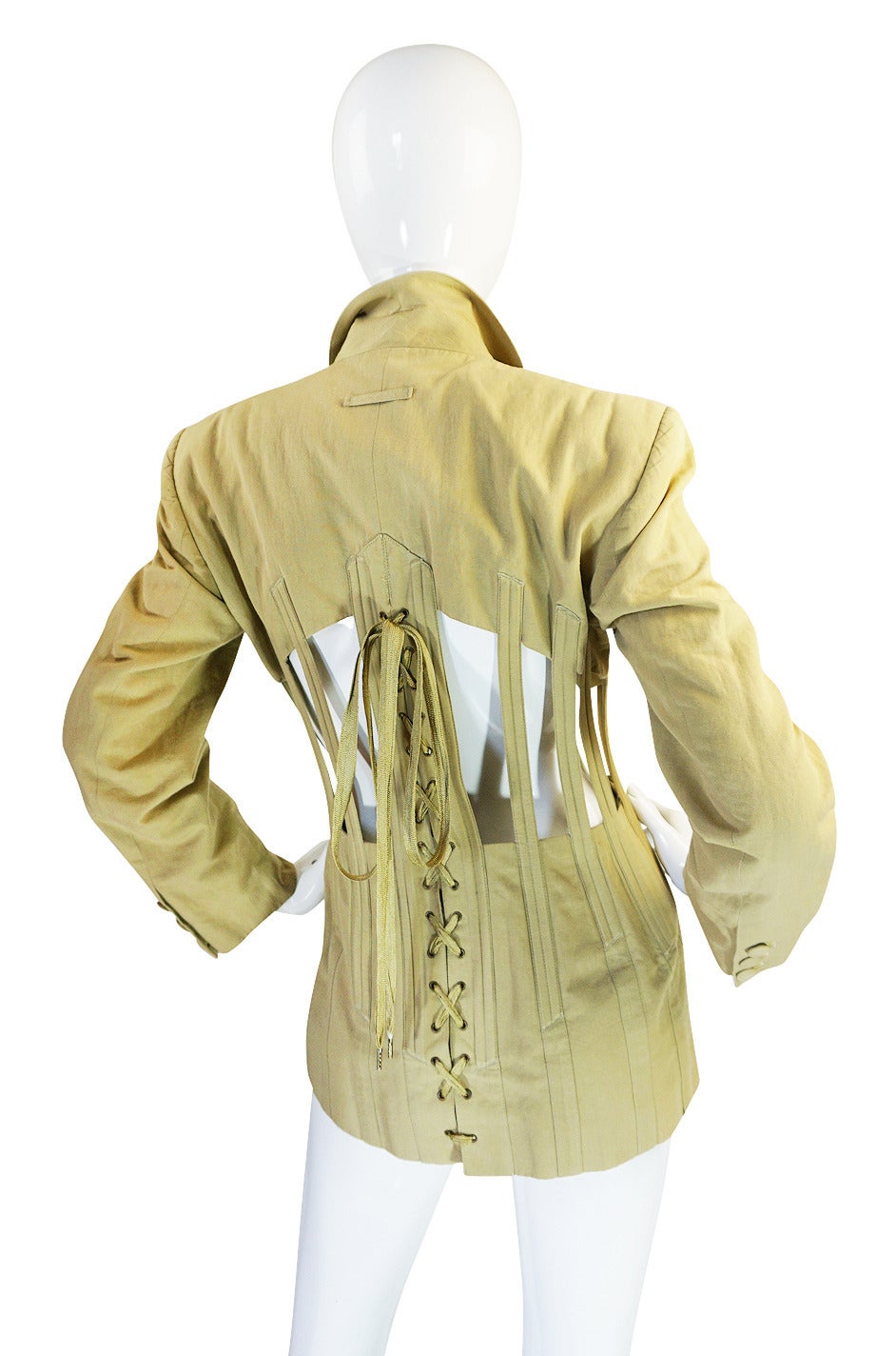 This iconic Jean Paul Gaultier jacket is one of his best known pieces and has issued in a couple of versions even up to recently. This in is dine in a safari green cotton khaki and the color acts like a neutral with most other colors. It has crisp