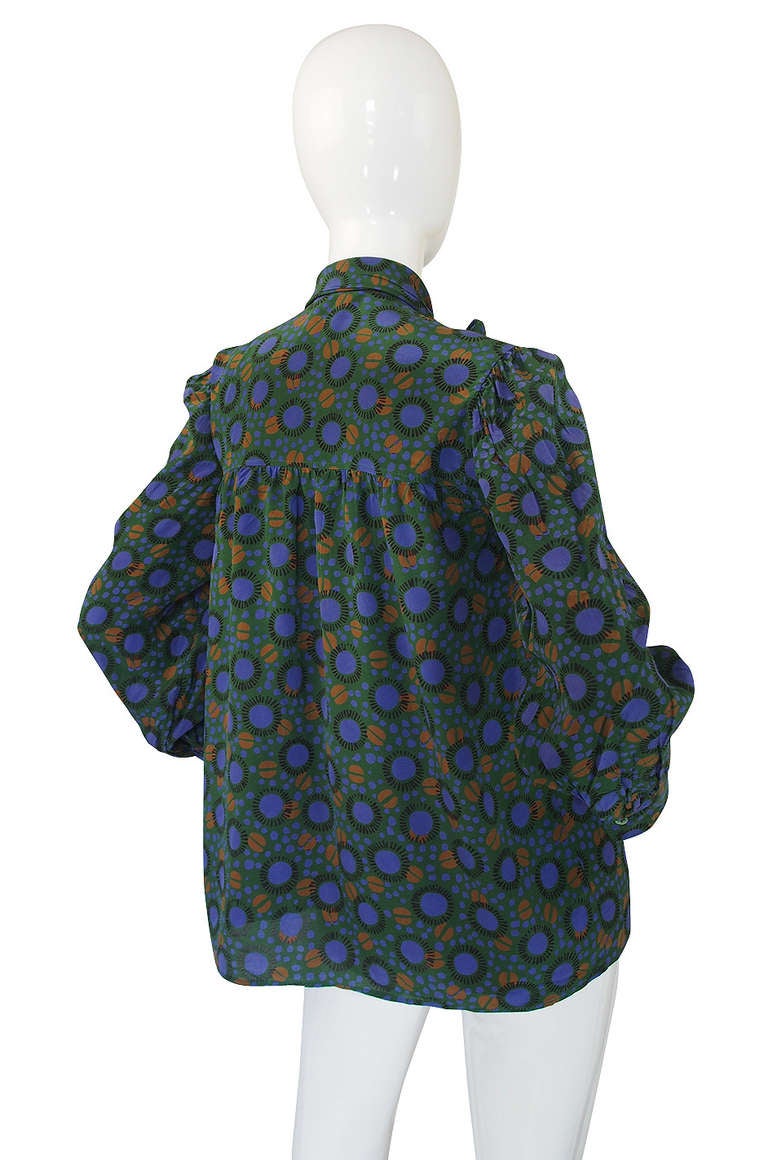 Classic silk blouse from Yves Saint Laurent with a fabulous print! It has that classic YSL tie at the neck - this one is wider then most and built right into the neckline as an extension of the top rather then being a separate tie like one usually