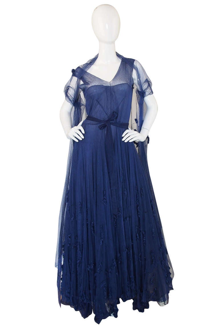 This gown and matching stole are absolutely beautiful and a testament to the man who would become the appointed designer to the Queen of England. Norman Hartnell was one of the British Couturiers who dressed the royals and the aristocrats. London's