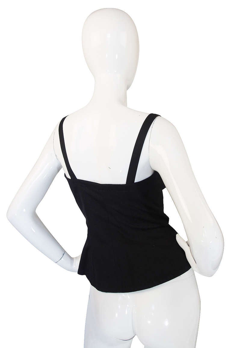 Perhaps one of the most iconic of all the YSL pieces, the laced corset top is one of those must have's in your vintage wardrobe. This is the (not so) basic black version. Made of a canvas weight cotton that gives it extra shape, it laces into place