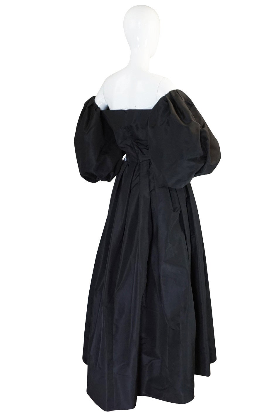 This is an over the top, unbelievable silk taffeta gown in a black silk taffeta by the great Pauline Trigere. The dress is both simple and at the same time elaborate and dramatic. Simple in that has been done in one solid color and the lines are so