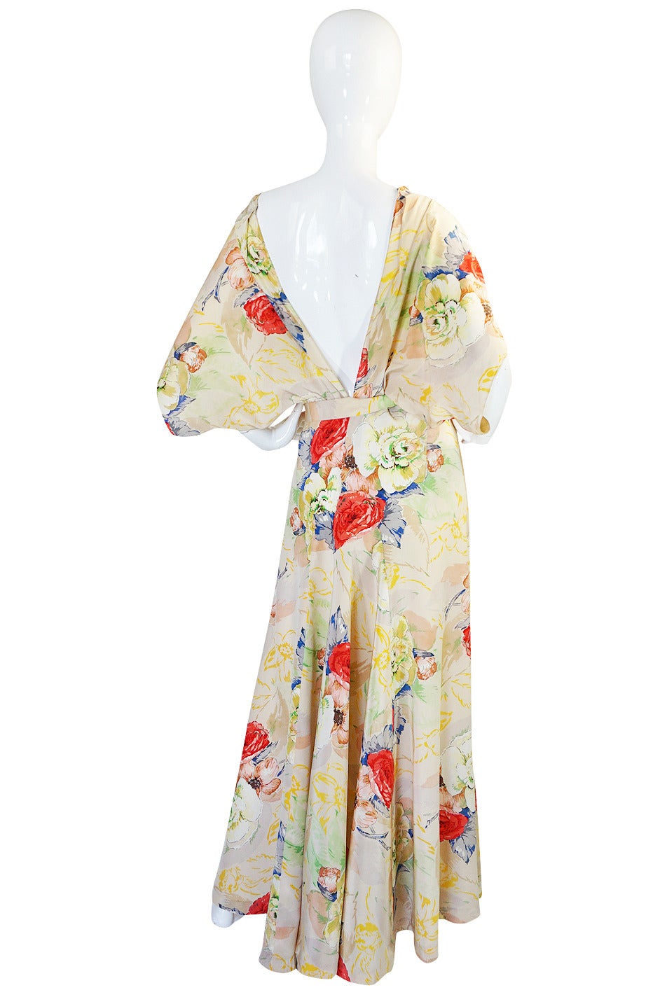 This thirties bias cut silk crepe gown is beautiful. It is completely cut on the bias so drapes and moves to fit you perfectly from the second you slip it over your head. The front has a soft and romantic capelet feel to it with a notched neckline