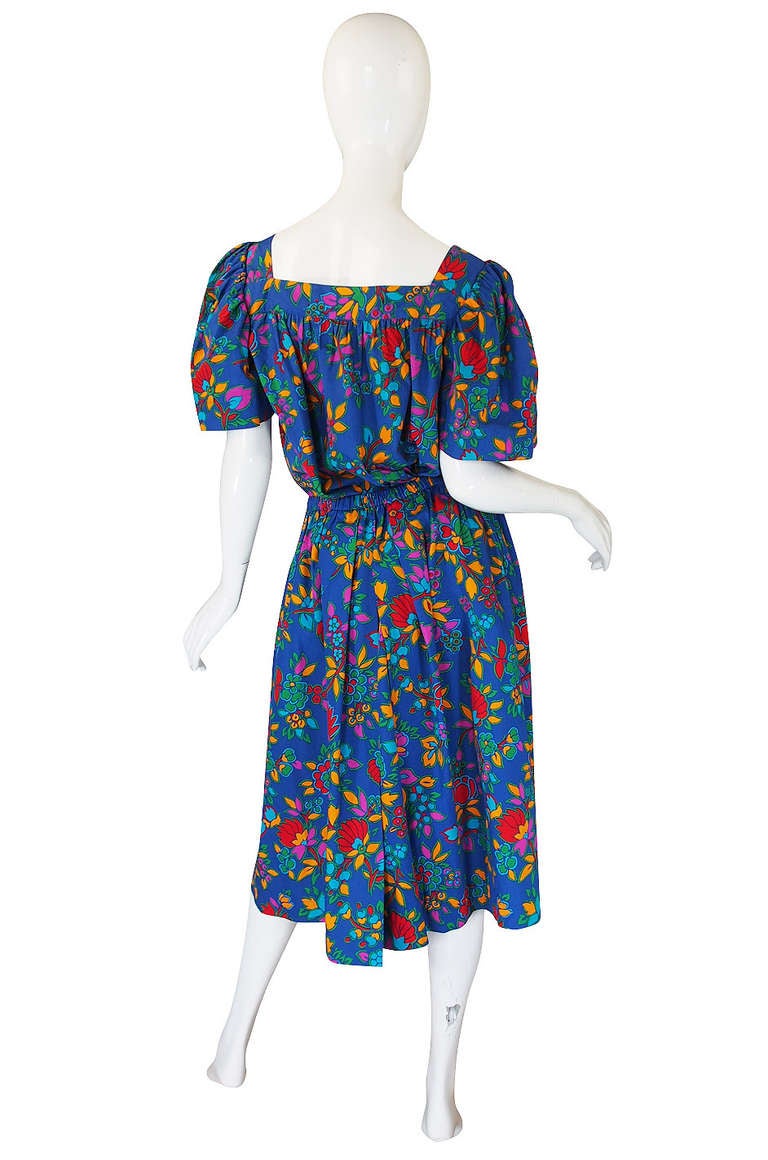 This amazing two piece set consists of a loose fitting pheasant style top and a fuller skirt. Both pieces are made of a crisp cotton that has been printed with one of Yves signature vibrant and bright prints. The top is cut smock style with a