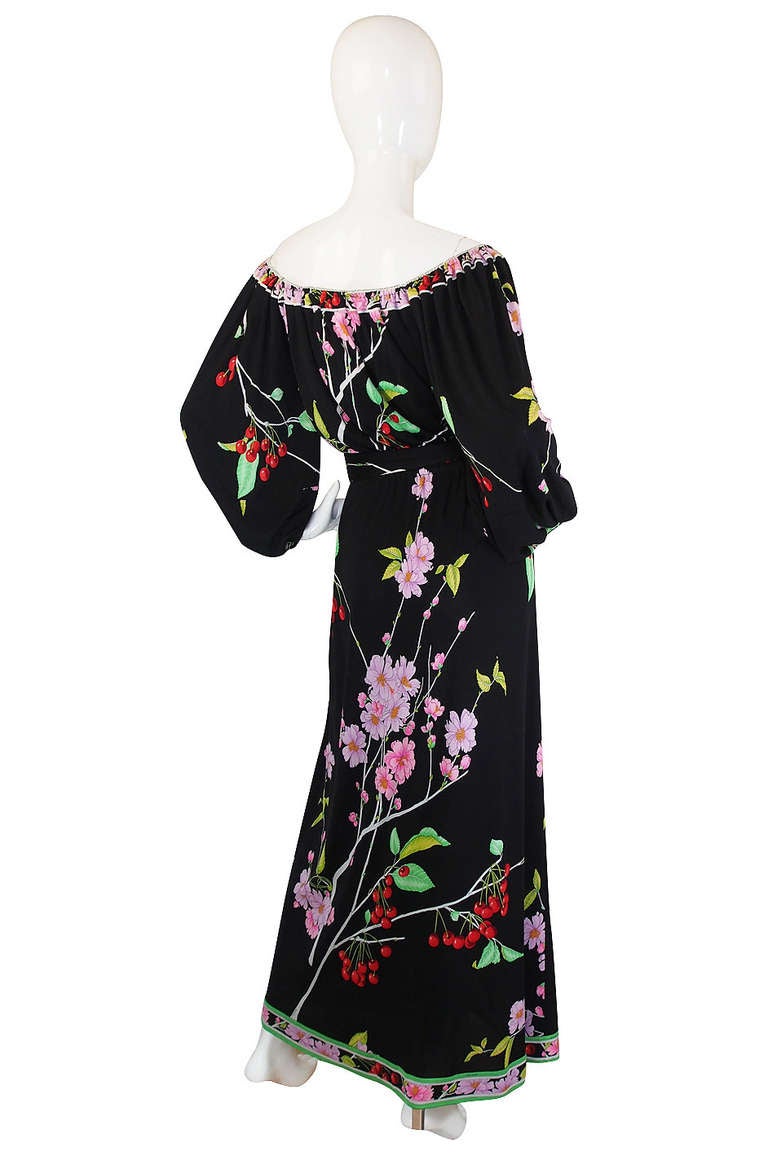 What a fabulous 1970s Leonard caftan feel maxi dress that has been done in the most gorgeous palette of bright pop of color on a black silk jersey backdrop. I love the loose cut through the skirt and body that flows to the ground and gives it that