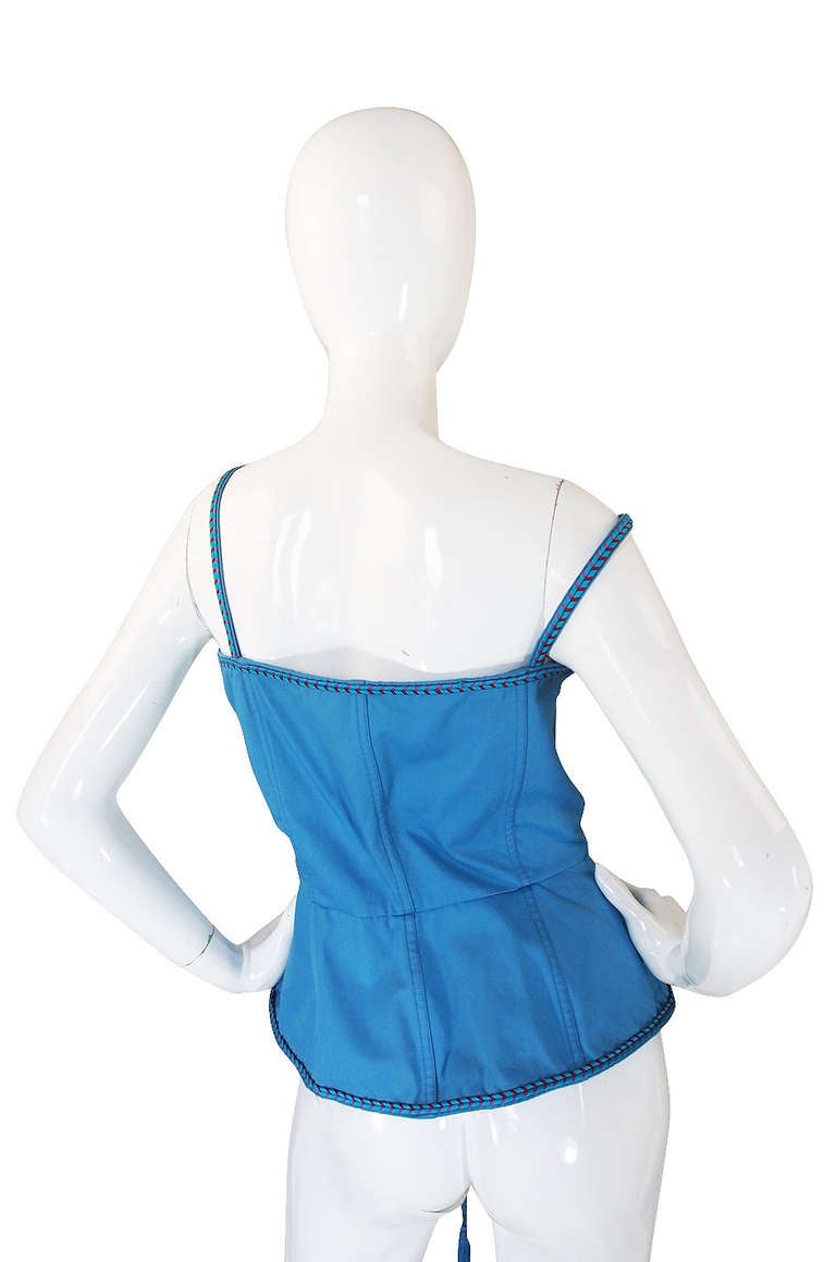 Perhaps one of the most iconic of all the YSL pieces, the laced corset top is one of those must have's in your vintage wardrobe. This one is super rare and special with it being done in that amazing robins egg blue. It is edged in a blue and red