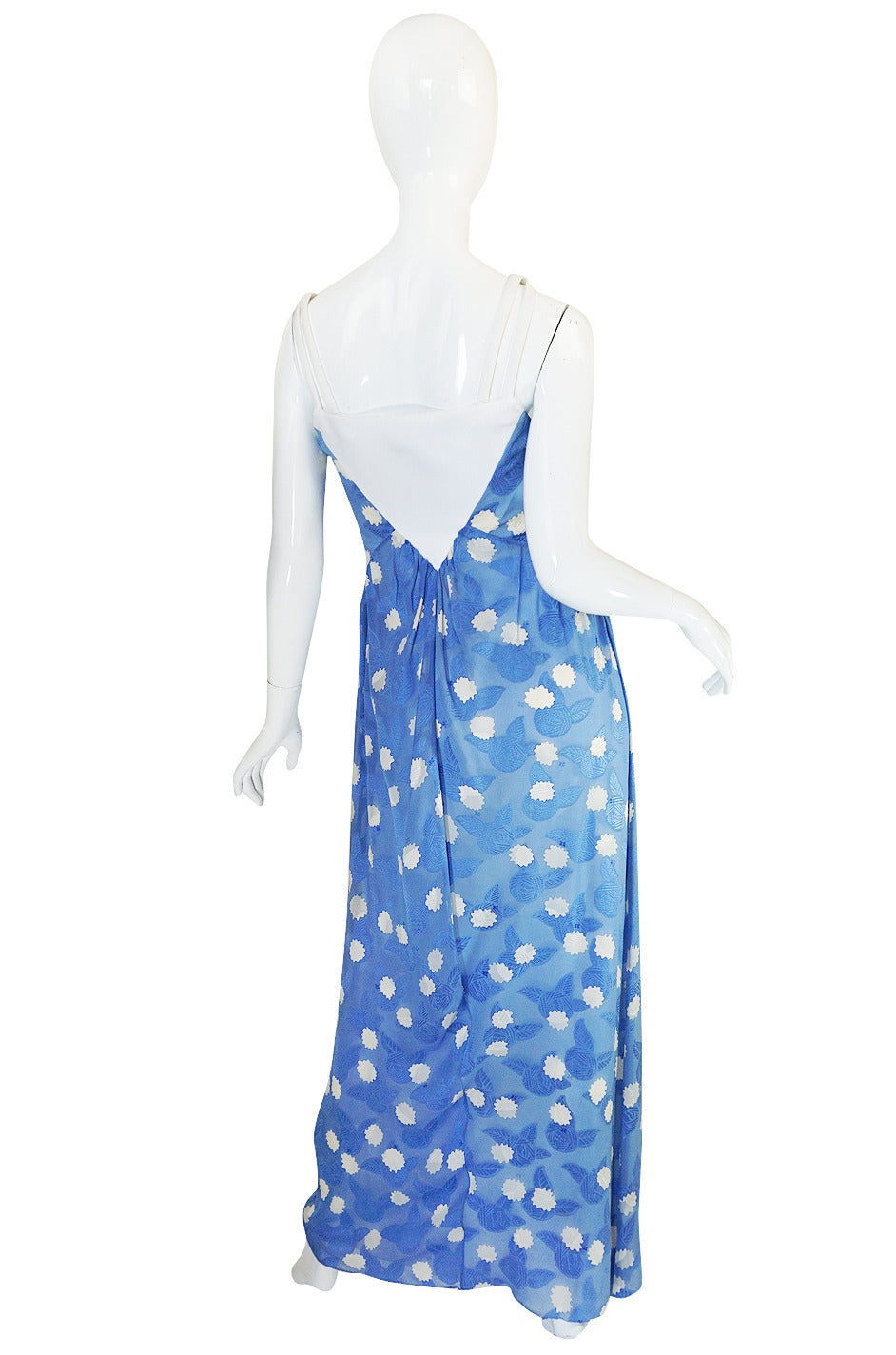 I am crazy for this dress. It is so unusual and so pretty and looks fabulous on. The blue fabric is a fine silk chiffon that has a textured design woven in tot eh fabric. Over that are little pops of white and scattered amongst those the Courreges