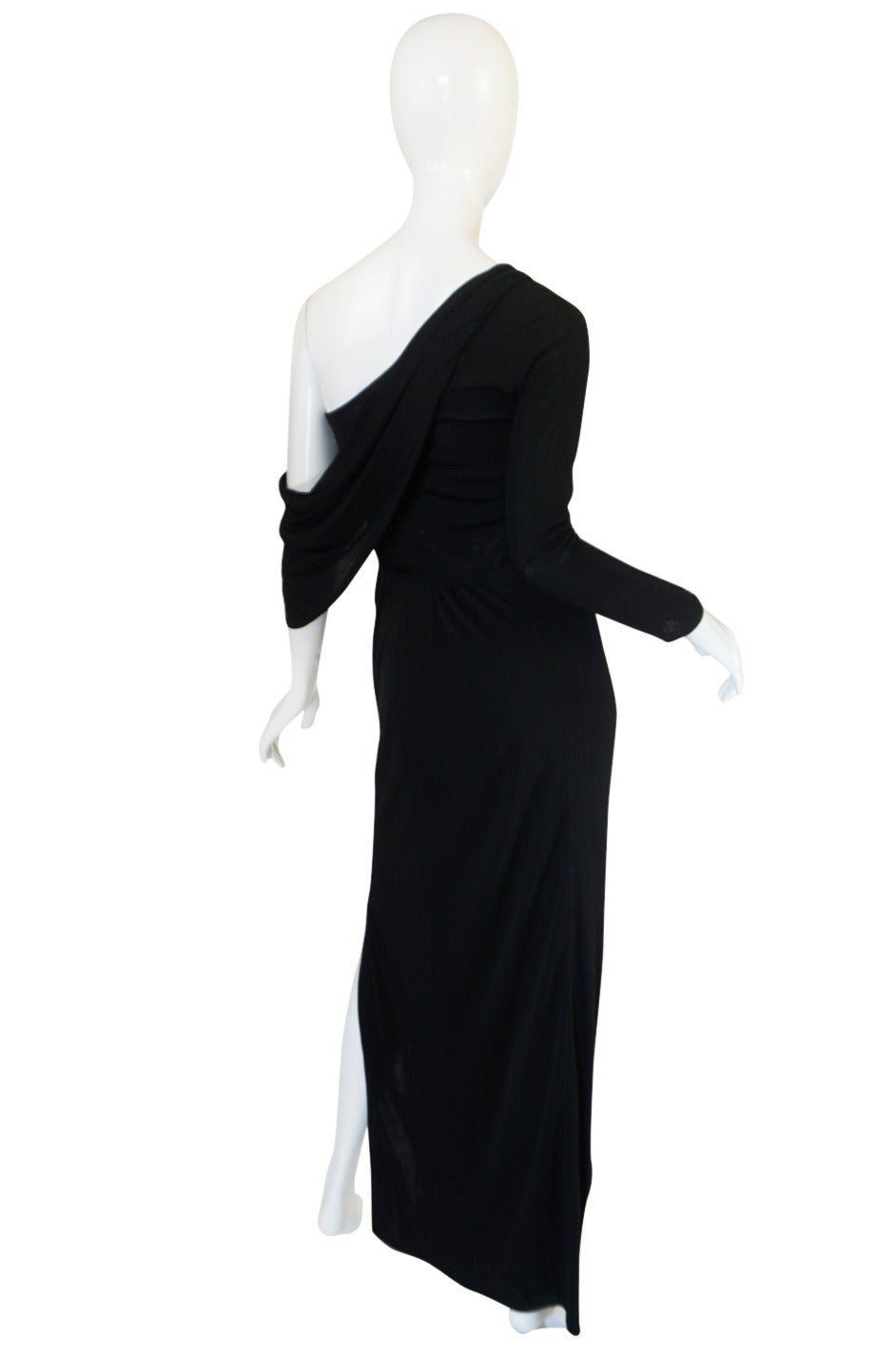 John Anthony opened his label in 1971 and during the seventies produced amazing pieces that were sleek and sexy. This particular dress from the late seventies is genius. The soft draped detail on the bust is hand placed and set to soften the fitted