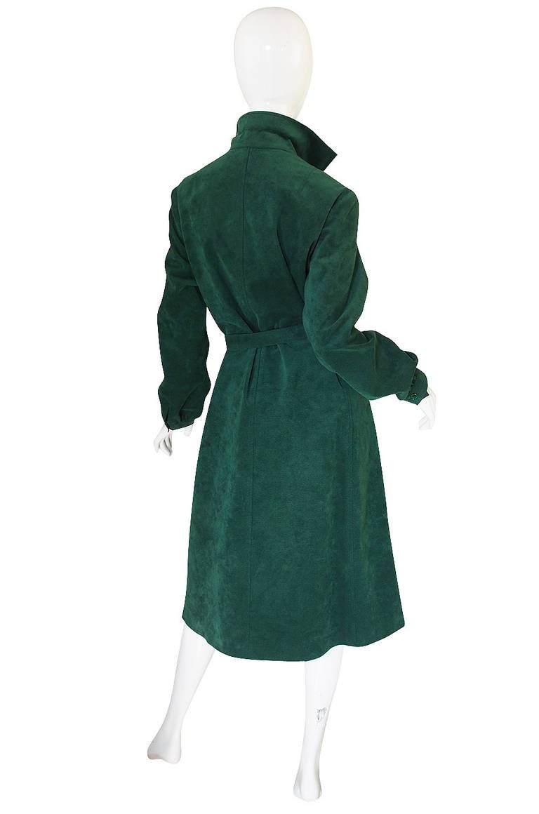 This fabulous 1972 ultrasuede shirt dress is done in a brilliant emerald green color. These were THE thing to own in the 1970's - no one had seen this fabric before and they were all the rage! Similar examples are held in The Met's permanent