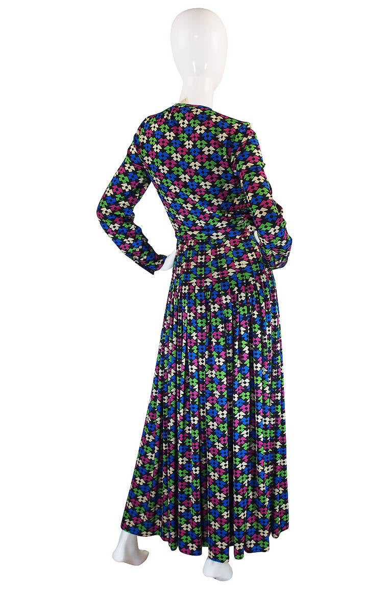 Constructed of a simple silk jersey, the exterior of this full length dress is deceptively simple. But once you look inside you realize that it is carefully constructed with a full lining in a beautiful and fine silk chiffon. At the time this was