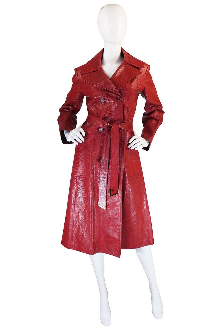 This just might be the holy grail of all Gucci coats! It is extraordinary and amazingly beautiful. The coat is made of a hand dyed snakeskin in a beautiful, rich red hue. It has its original, detachable fox fur collar that is also dyed to match