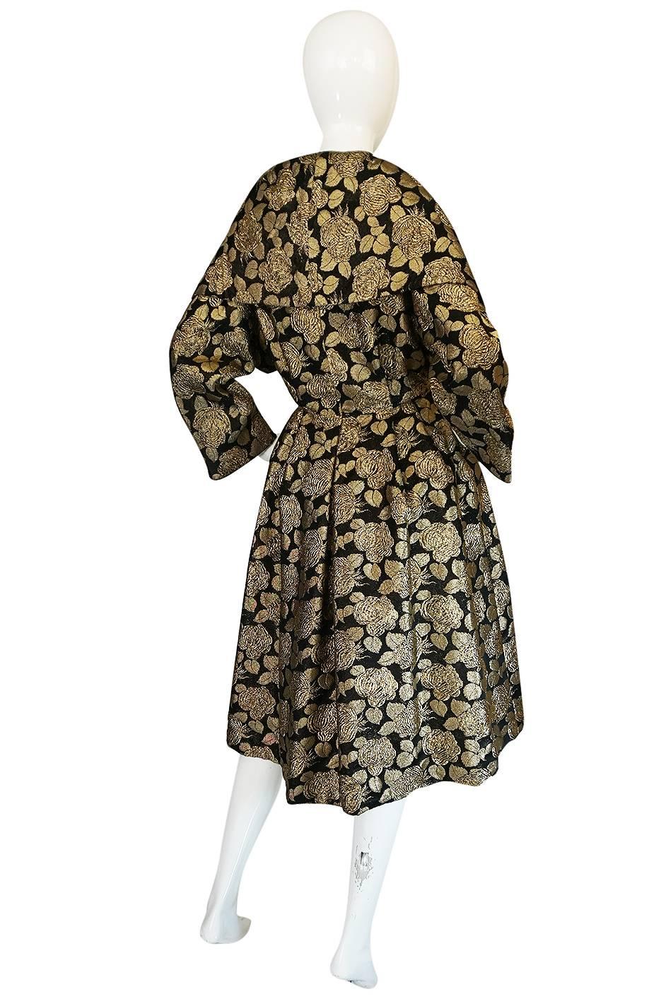 

The fabric on this coat is amazing. The gold thread used is a real metallic thread and it is woven through the black base with different weaves to create the most wonderful effect and allow the rose pattern to feel like it is raised off the