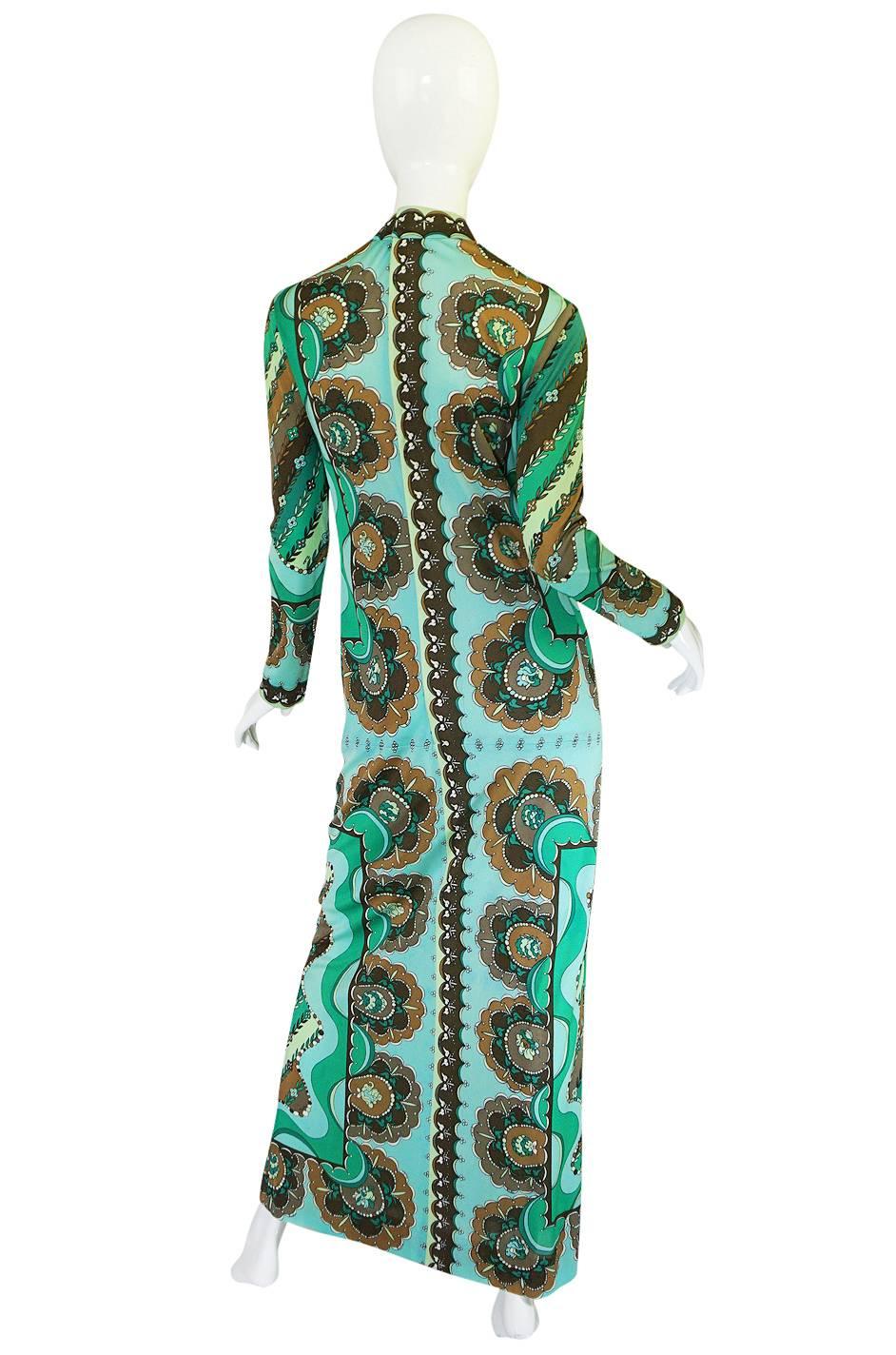 

This is absolutely gorgeous Pucci dress with a superb color palette in shade of green mixed with taupes to create one of his signature prints. It is made of a lightweight silk jersey, a preferred fabric choice for Pucci because of how it draped