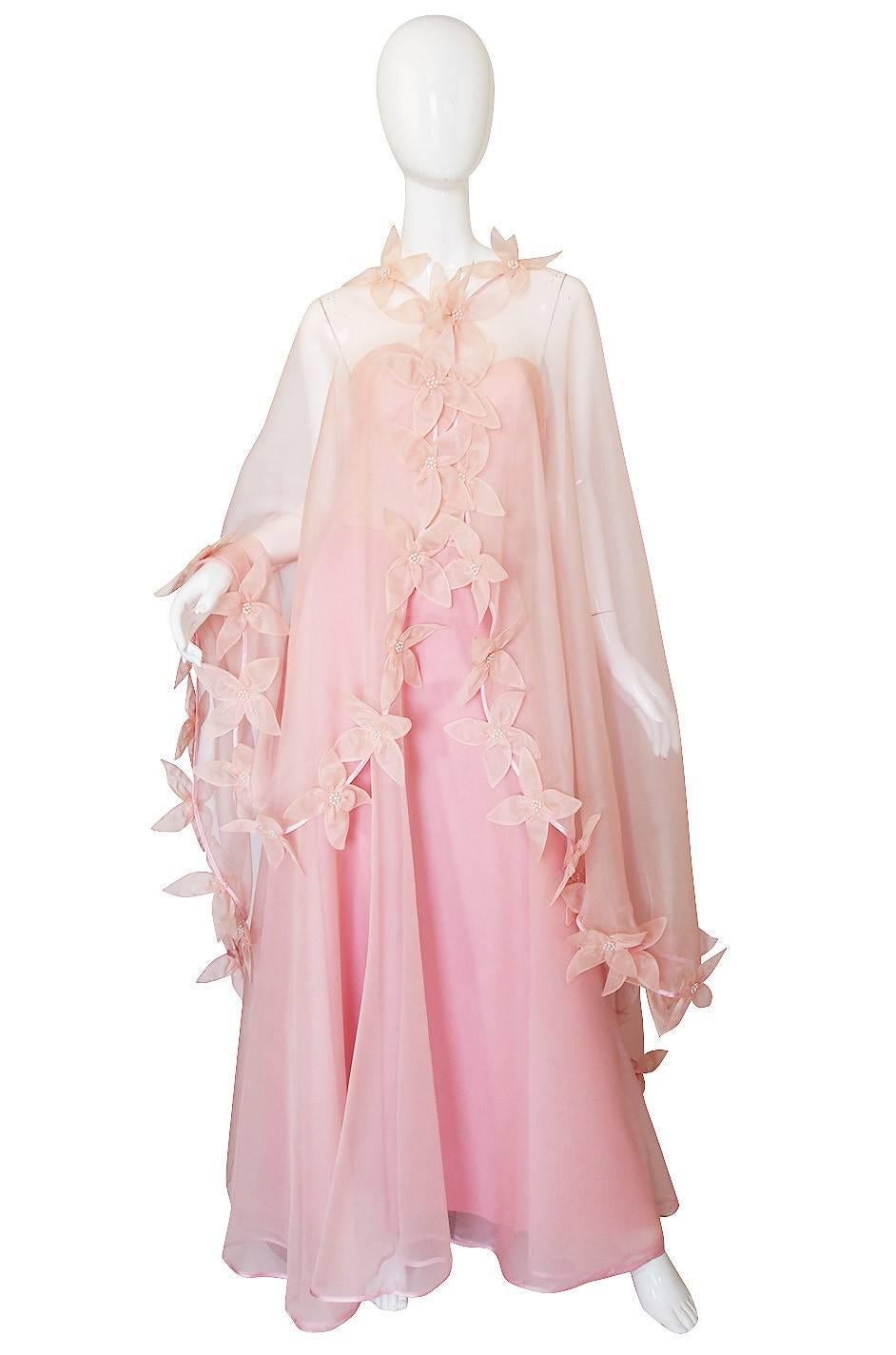 This stunning and dramatic pink silk organza gown was made for my client in 1975 by Loris Azzaro at his atelier. You so rarely see his Haute Couture pieces anywhere and to have one as incredible as this is just a treat. Azzaro was a favorite of