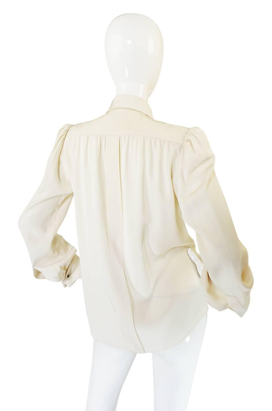 This beautiful silk blouse was produced and made by hand, under Yves Saint Laurent himself. It is a true treasure. Haute Couture is the very pinnacle of the fashion experience and I would hazard to say that vintage versions are even a little more