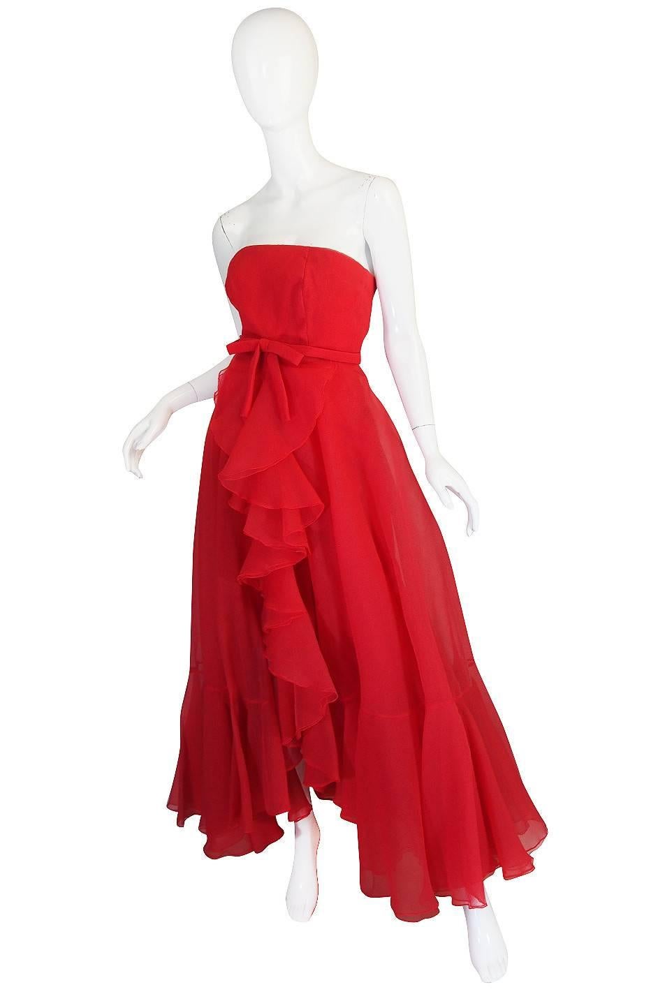 I love this dress with its explosion of ruffles and feeling of airiness. It feels like it just floats around you once on. The gown is a silk organza in a fabulous red. The fabric has a touch of a wavy ribbed texture to it making it very interesting.