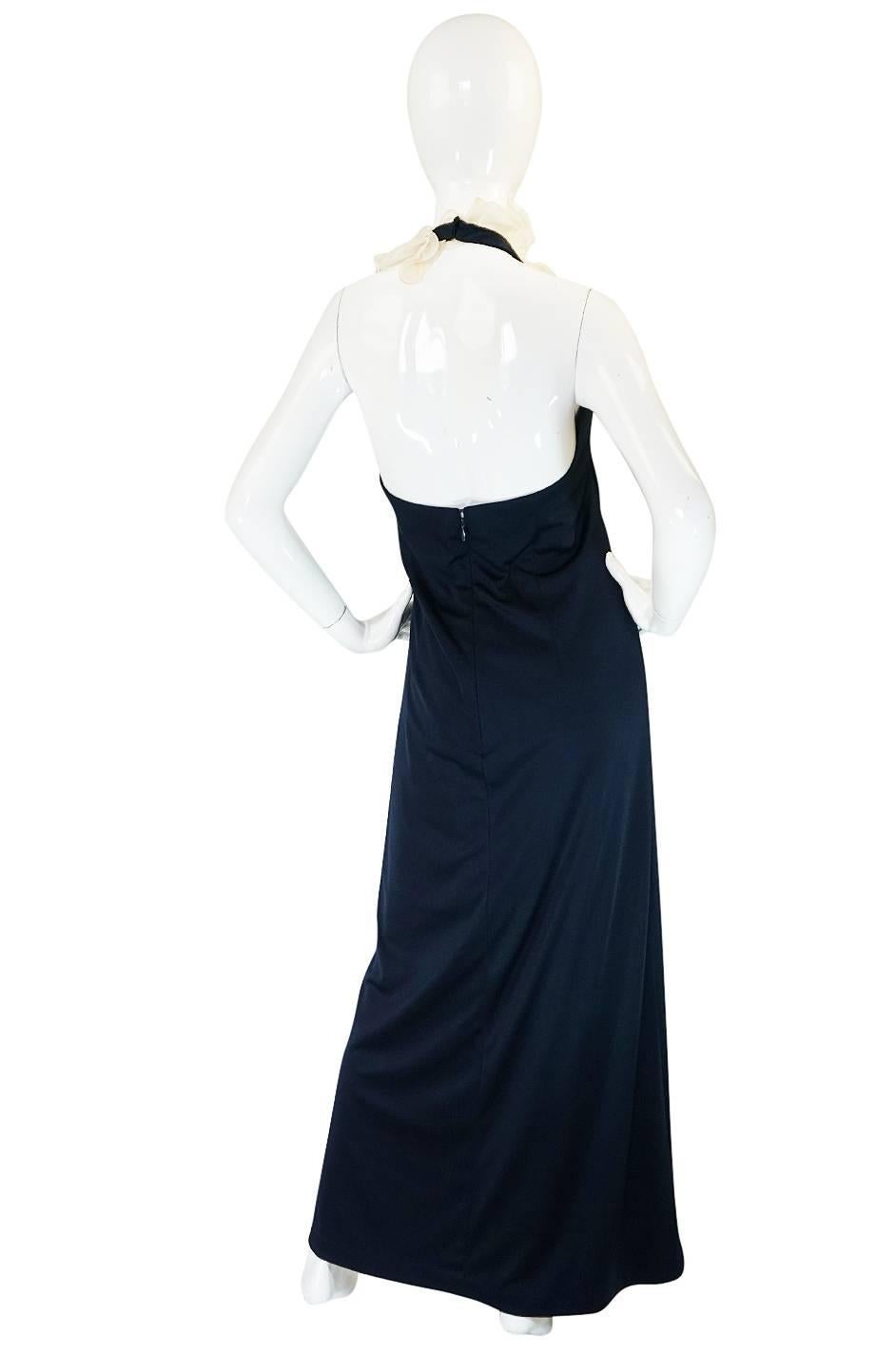 

I love the combination of jersey and ruffles on this dress combined with the slinky feel and sexy backless cut. The dress itself is made of a deep navy blue jersey so has a wonderful drape and fall to it once on the body. The halter sweeps up