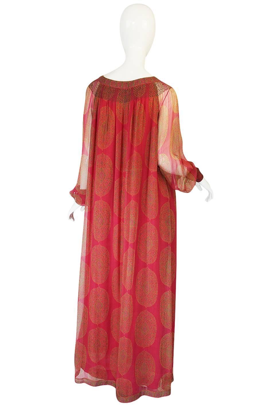 

The color of this wonderful caftan dress is fantastic - it is a deep rich pink in a brilliant jeweled hue. It is cut with a gathered and ruched neckline and upper bodice where the fabric has been gathered with tiny cross stitched thatch work for