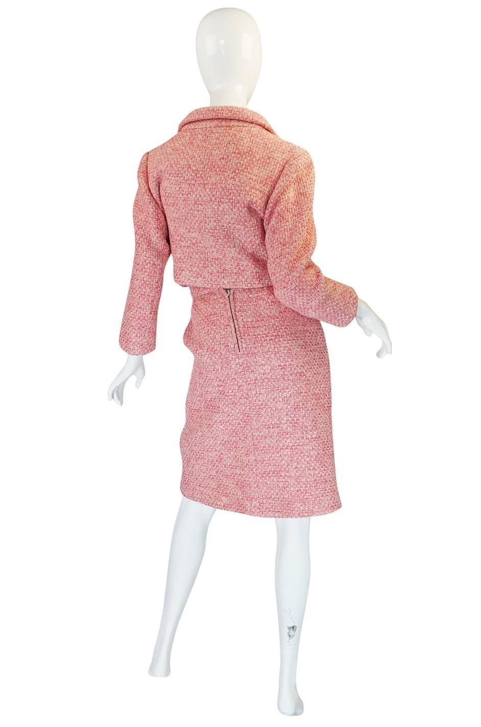 

A Norman Norell suit is always a classic and this one is exceptional - both for its avant garde and modern feel and also that it has been done in that incredible pink color. The fabric is a decent weight for a boucle but it is not so thick that