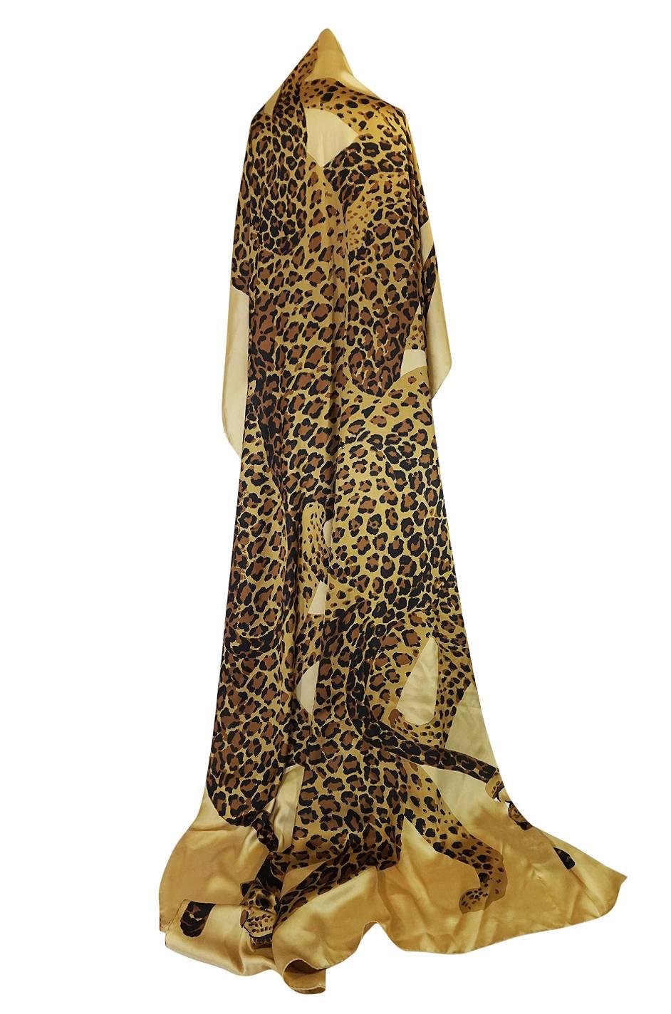 

This is one of the most unusual scarves or shawls that I have ever seen from Yves Saint Laurent and certainly the largest one I have ever seen. It is from the 1986 collection and depicts the leopards that he used extensively throughout that