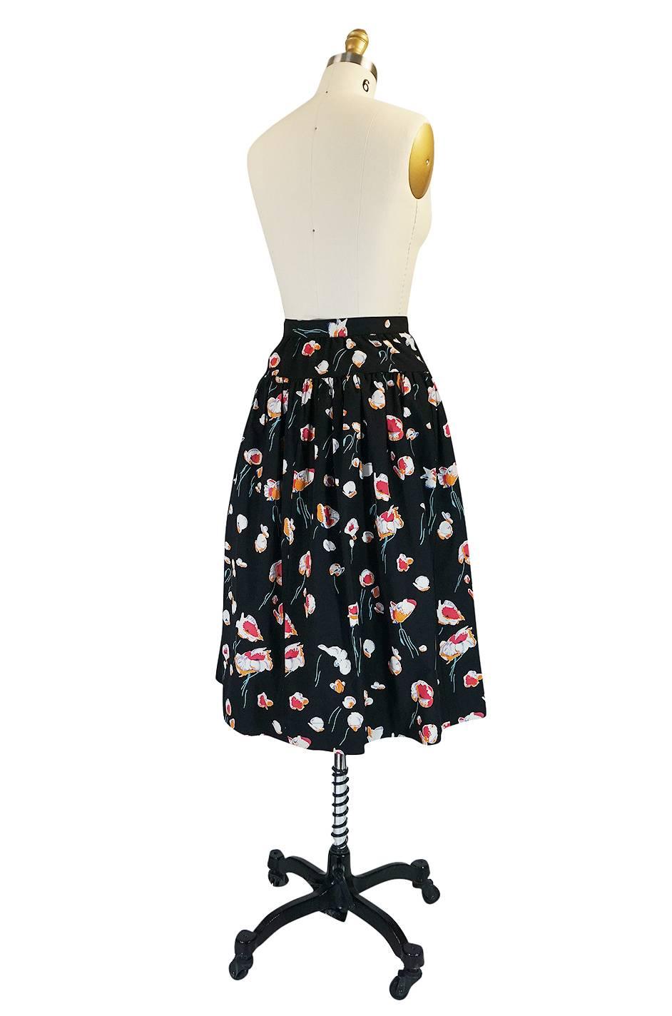 I love this fuller skirt by Yves Saint Laurent with its fifties feel and gorgeous floral print. It is made of a crisp cotton that has been printed with one of Yves signature prints. The waist cinches in and below that the skirt has a fabulous