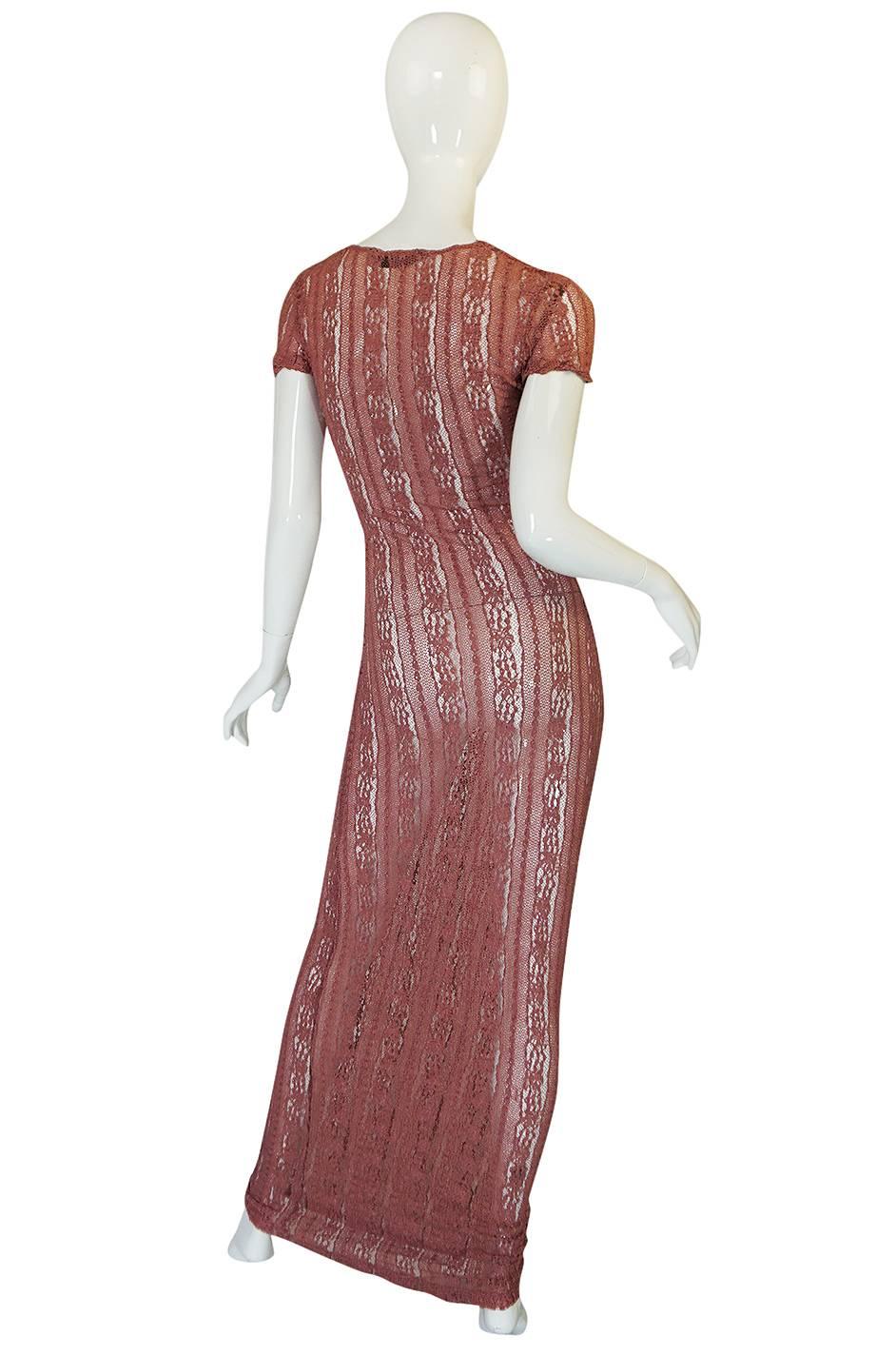 

This dress is from Galliano's main line and dates to the nineties - which one can see not only from the version of his label seen inside in the dress but readily in the lines of the dress itself. It's long lean silhouette and fitted body-con cut