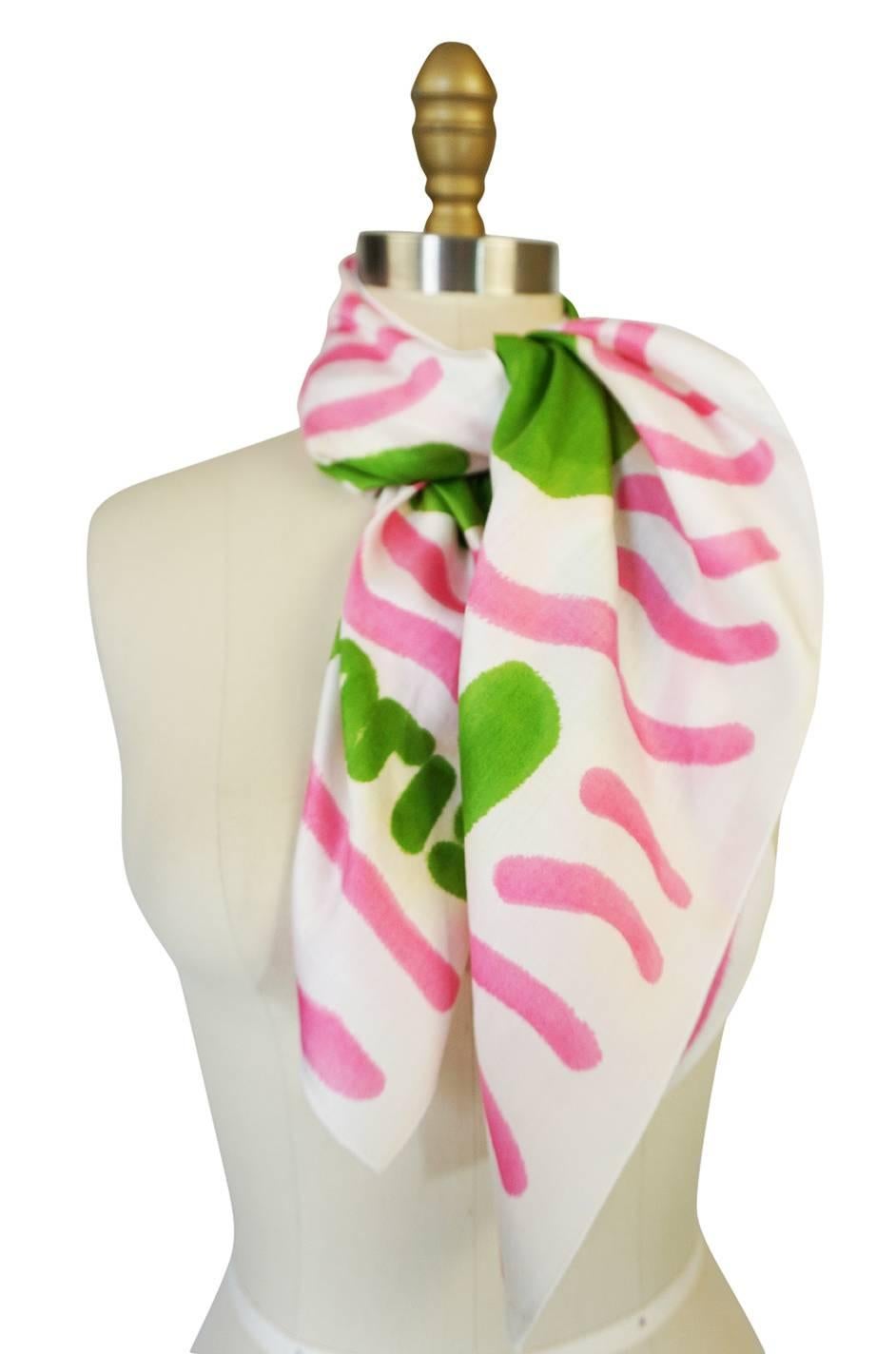

This Courreges scarf is quite fabulous and a beautiful and unusual piece. These were produced in and around 1970 and the designs all hand painted and then screened onto silk or cotton. This version is a light fine, white cotton with the stunning