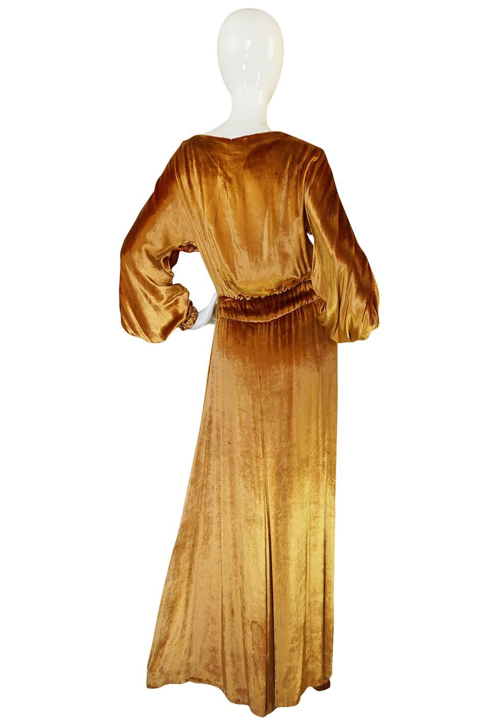 

This stunning and rare gown by one of the great couturiers is an absolute wonderful find and a true treasure. It is also incredibly beautiful and the fabric choice with its lush, liquid appearance only adds to that beauty. The color is a deep